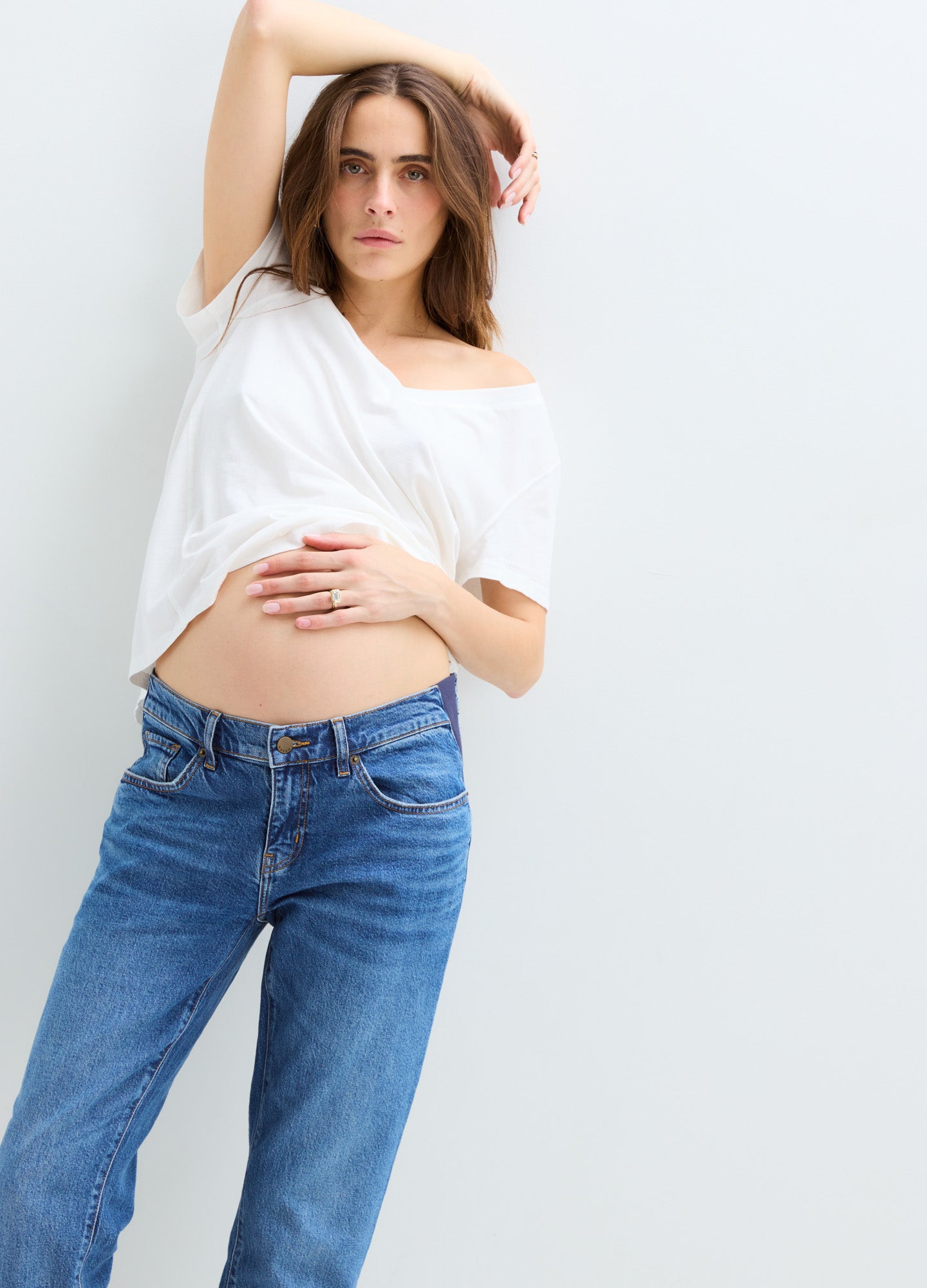 Blue denim maternity boyfriend jeans with a relaxed fit and adjustable waistband, worn by a pregnant model.