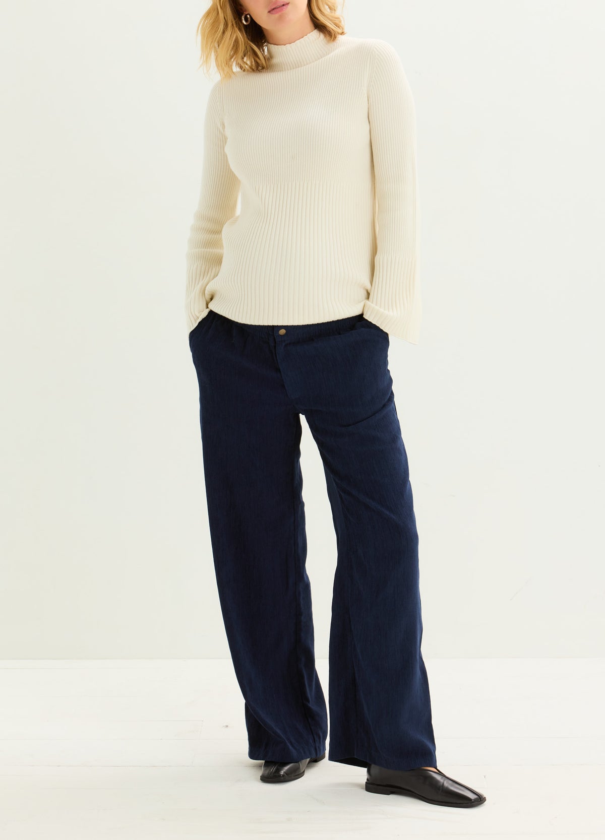 Navy maternity corduroy pants with a relaxed wide-leg fit, styled for a comfortable pregnant look.