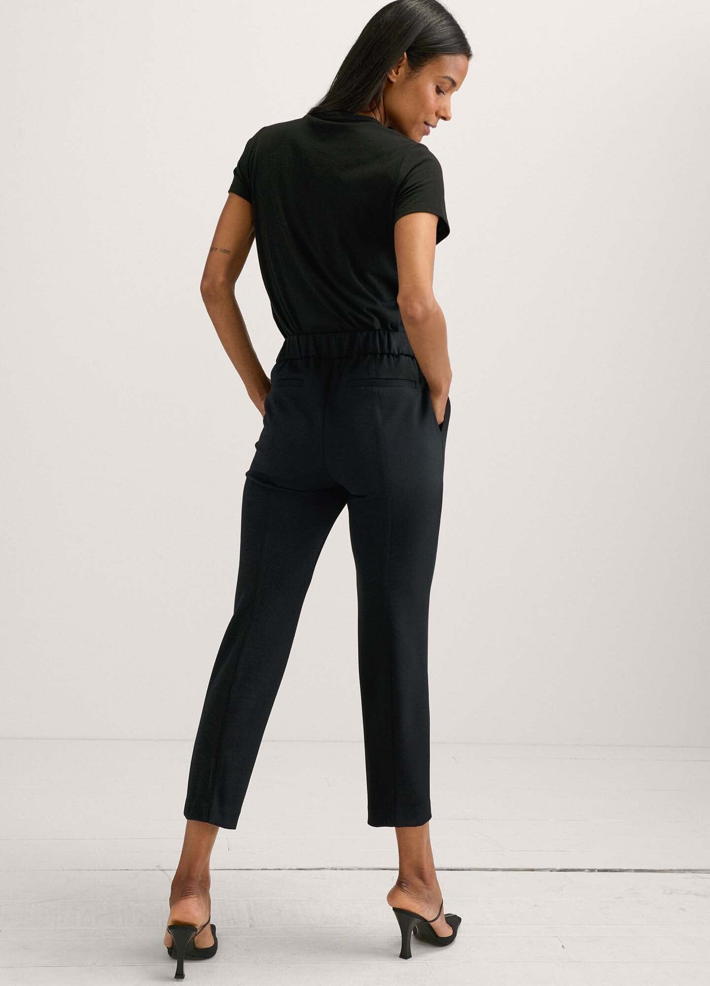 The HATCH Stretch Suit Pant - Black maternity stretch suit pants with tapered legs and front pockets, styled for pregnancy and postpartum wear.