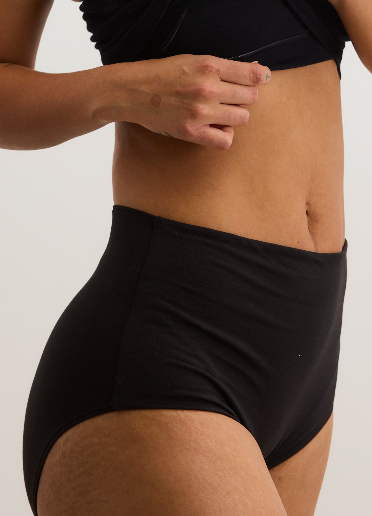 Black high-waisted maternity brief with smooth, stretchy fabric and full coverage design.