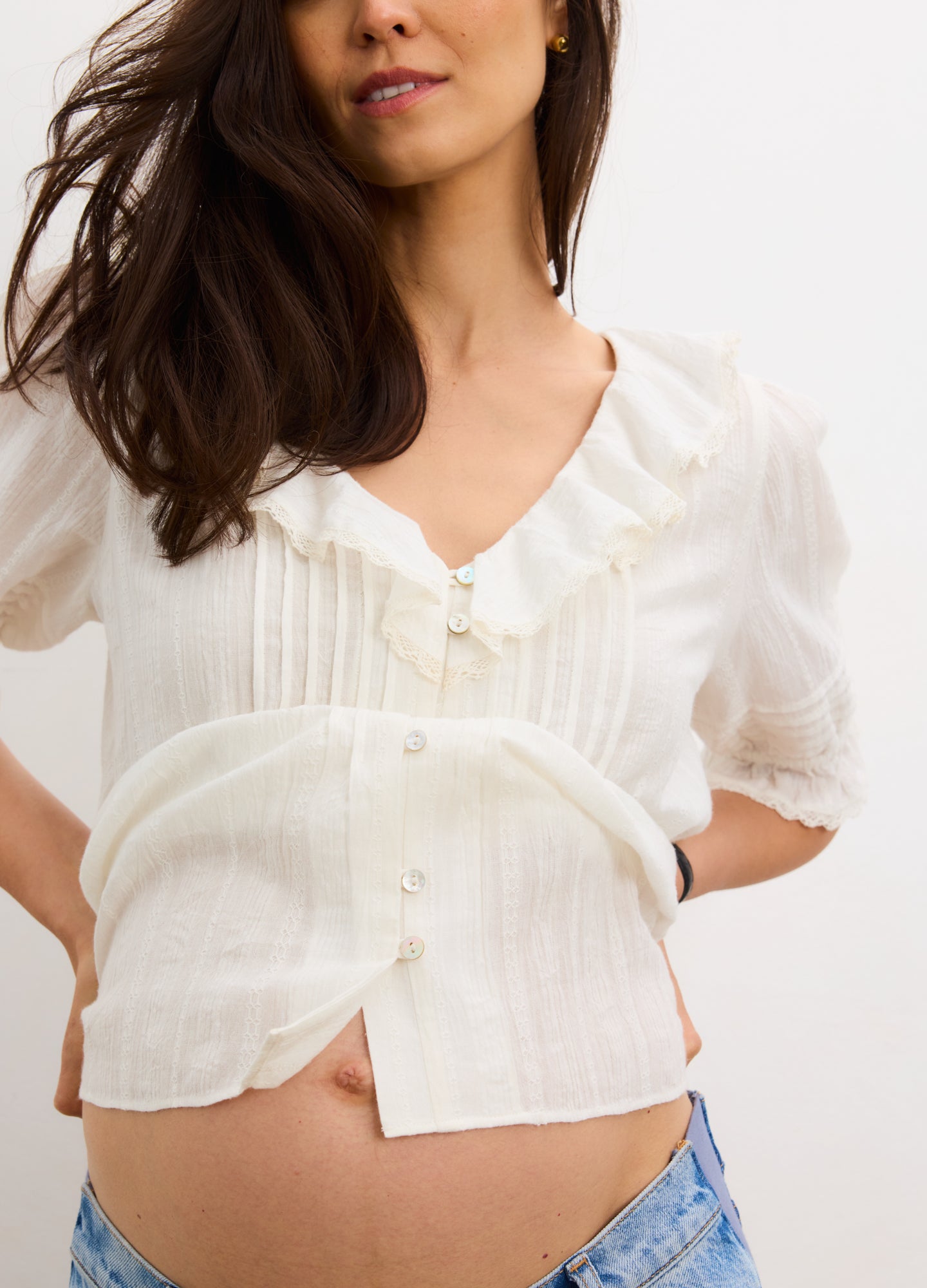 Cream-colored maternity nursing blouse with short puff sleeves, front buttons, and soft, lightweight fabric.
