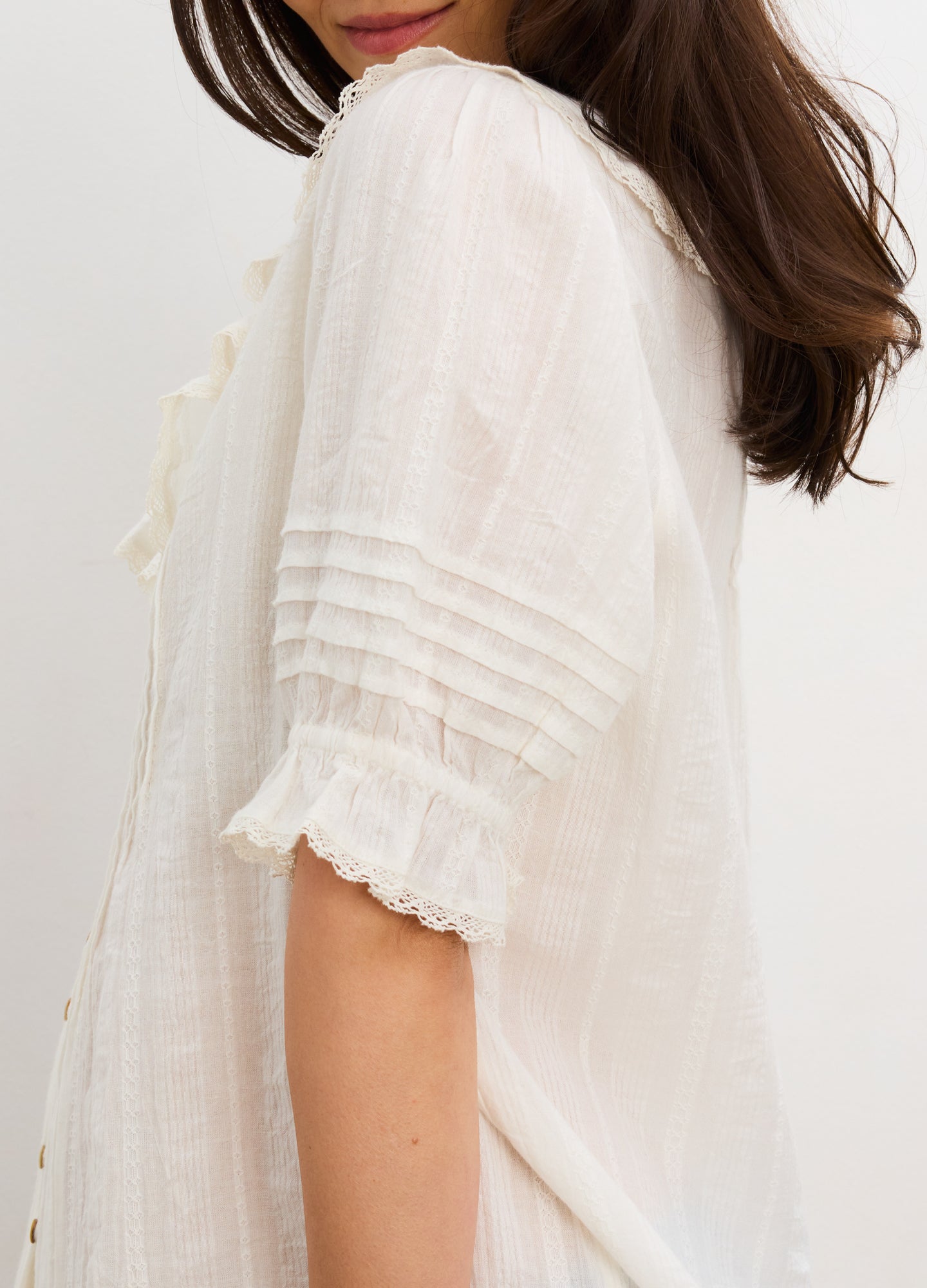 White maternity nursing blouse with pintuck sleeves and delicate lace trim on cuff.