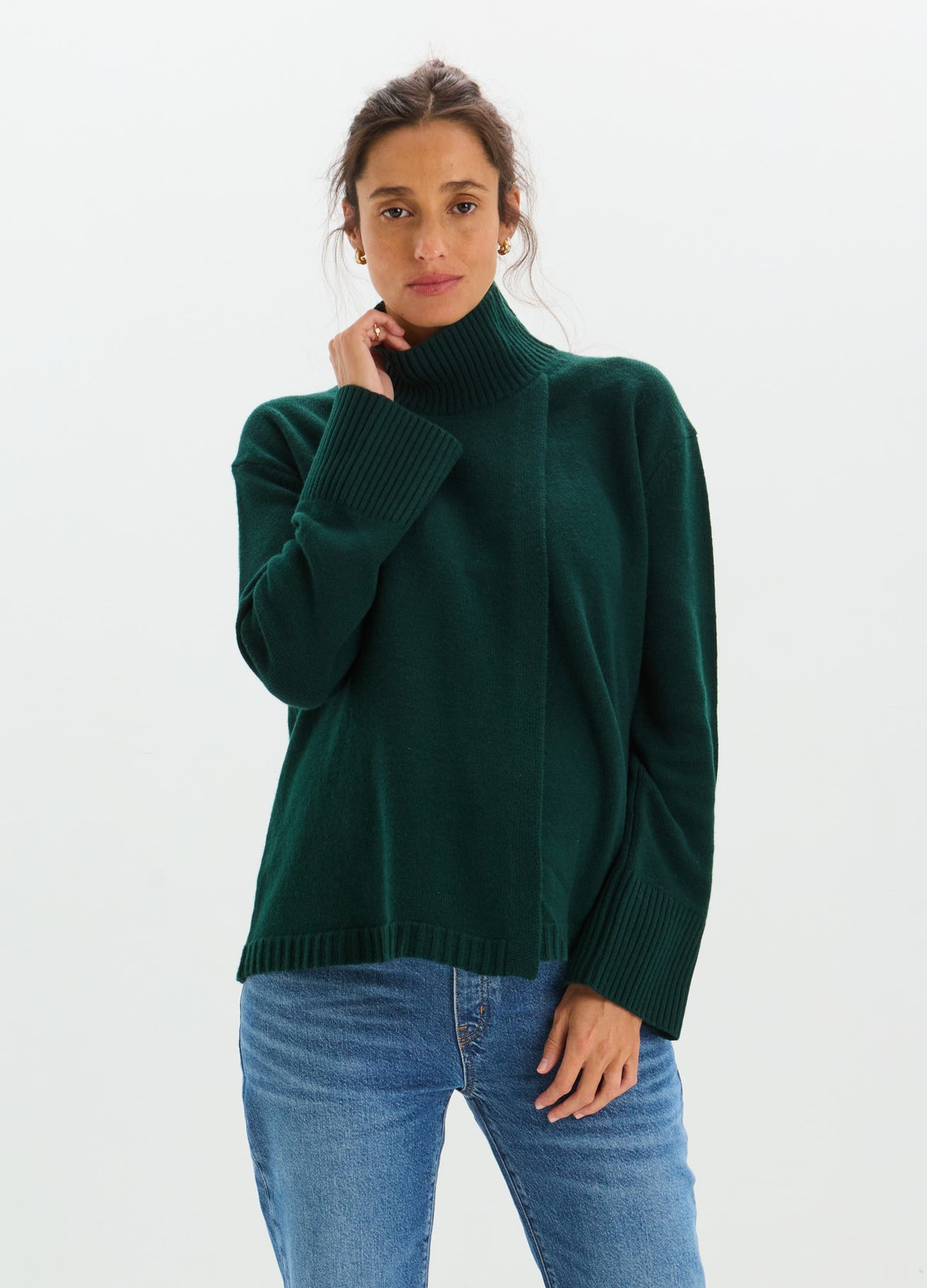Pregnancy-friendly dark green maternity turtleneck with a relaxed fit, long sleeves, and ribbed cuffs.