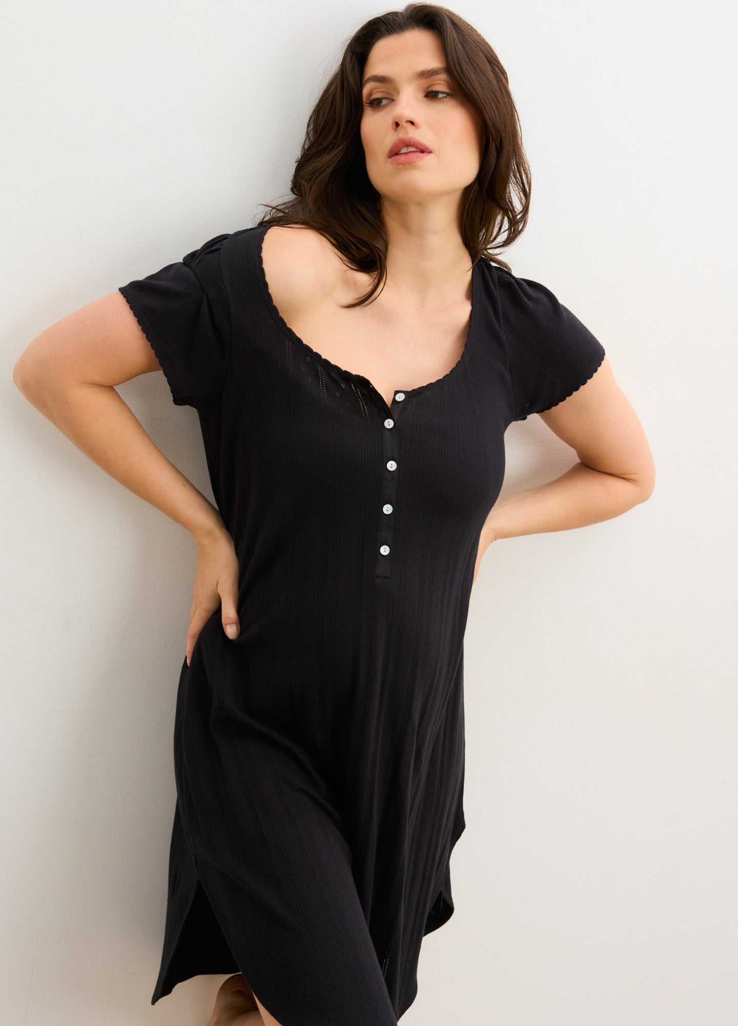 Black maternity nightgown with short sleeves, button-front detail, and soft stretchy fabric for pregnant comfort.