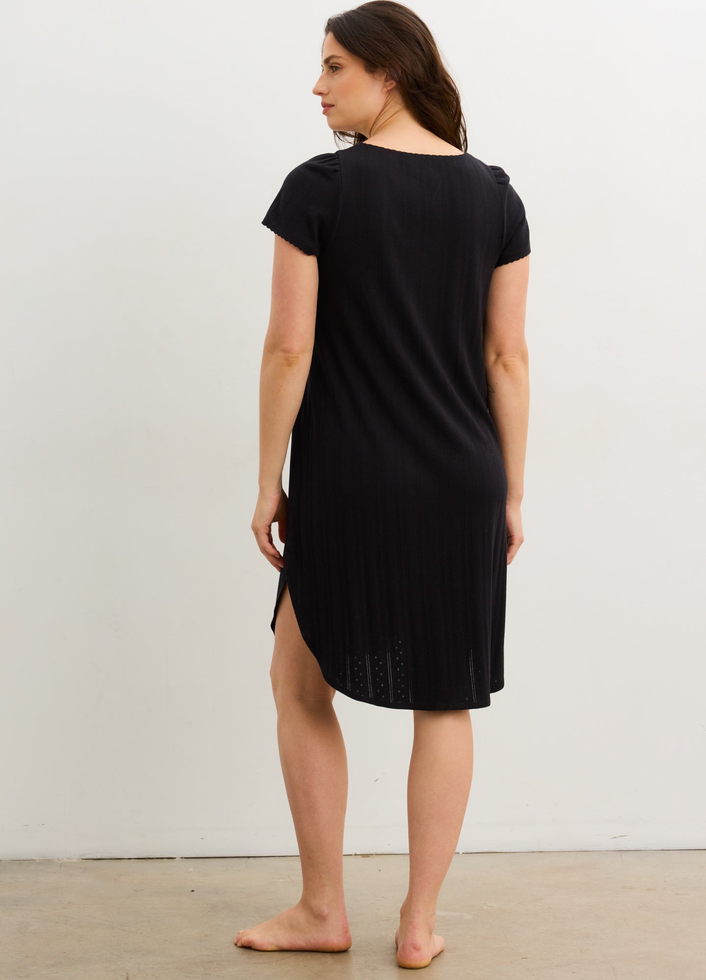 Black short-sleeve maternity nightgown with a relaxed fit and side slits, midi length.