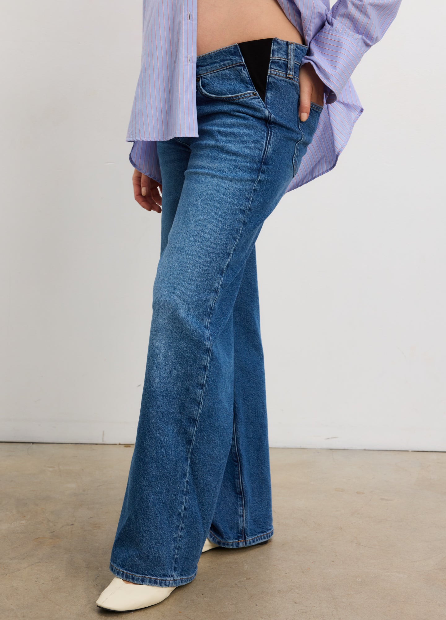 True indigo wide leg maternity jeans with elastic belly panel, worn by pregnant model.