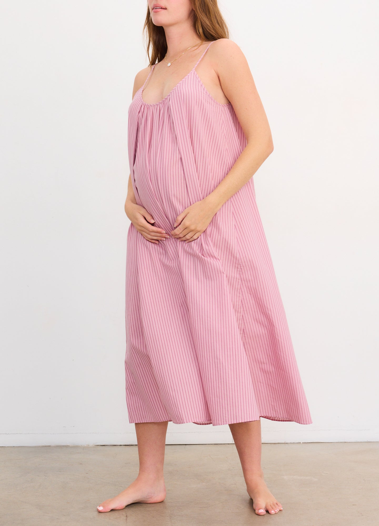 Light pink cotton nursing nightgown with thin straps and loose, flowing fit designed for maternity comfort.