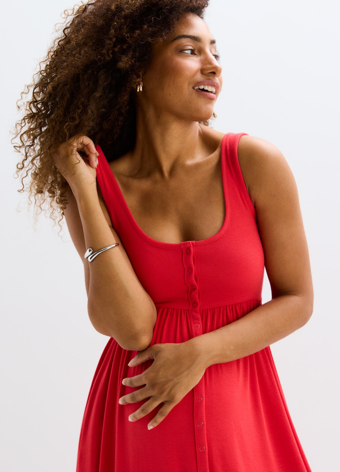Red ribbed nursing tank dress with button-front detail and fitted empire waist, sleeveless and knee-length.