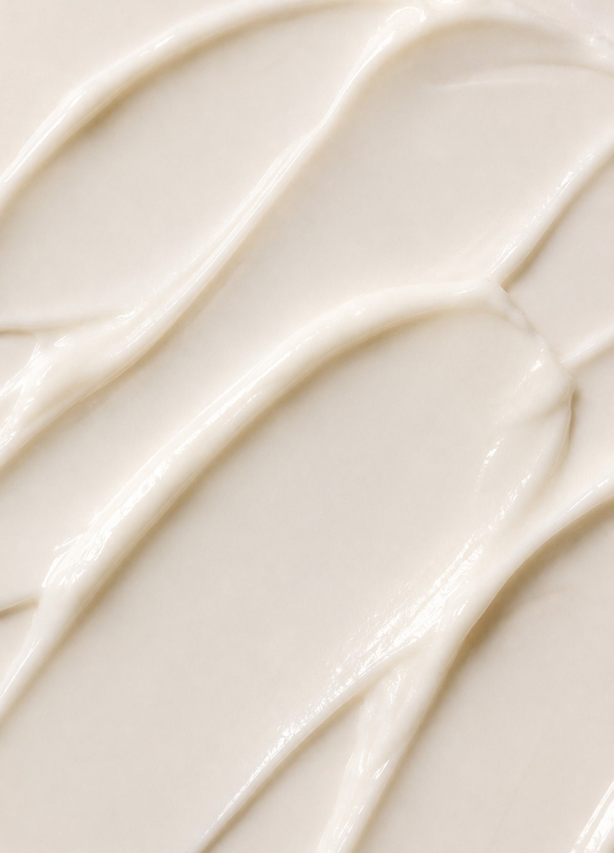 Smooth, creamy white balm texture with a glossy finish, ideal for hydration and soothing.