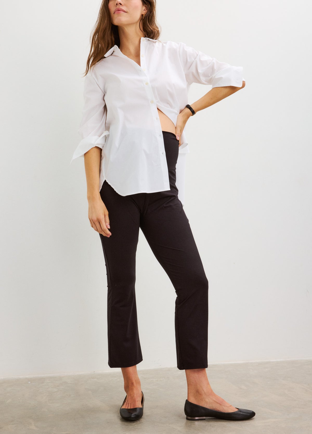 Black cropped flare maternity leggings with stretchy fabric and a mid-rise waistband.
