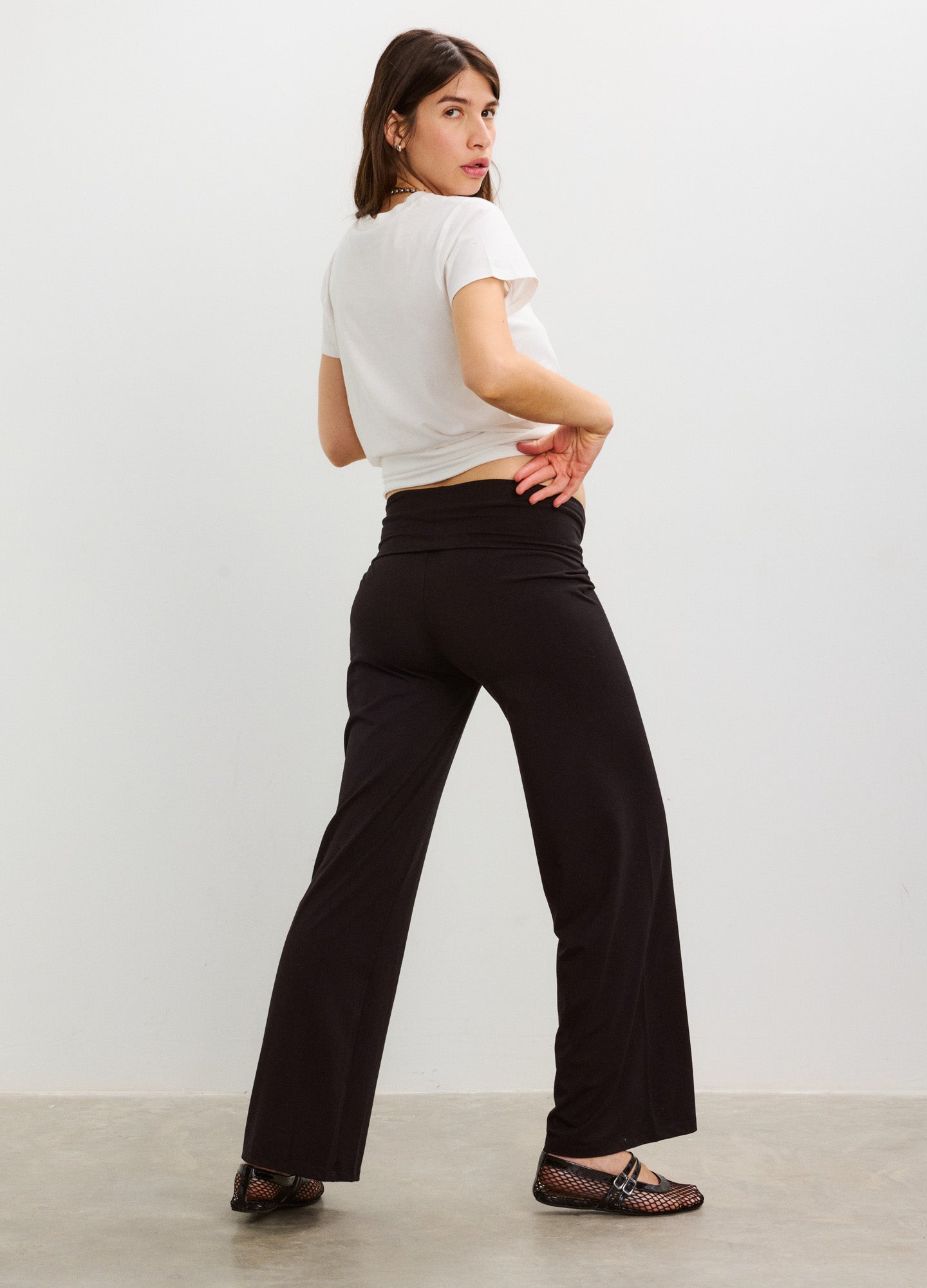 Black maternity lounge pants with wide legs and stretchy fabric, worn high on the waist.