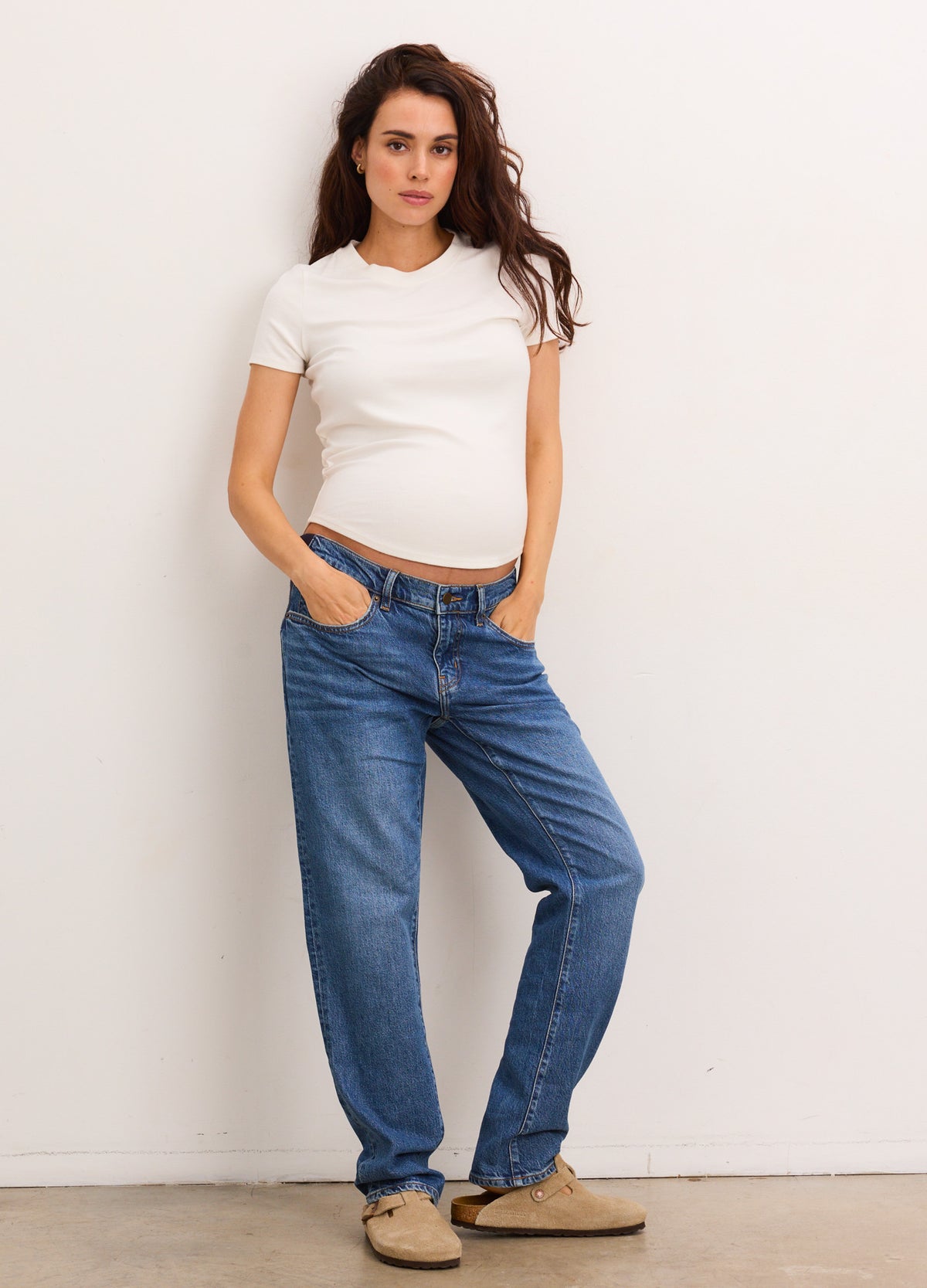 Blue denim maternity boyfriend jeans with relaxed fit and mid-rise waist designed for pregnant women.