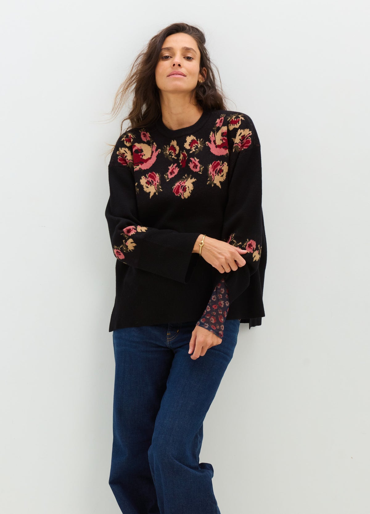 Black floral knit sweater with a relaxed fit and wide sleeves, styled for maternity wear.