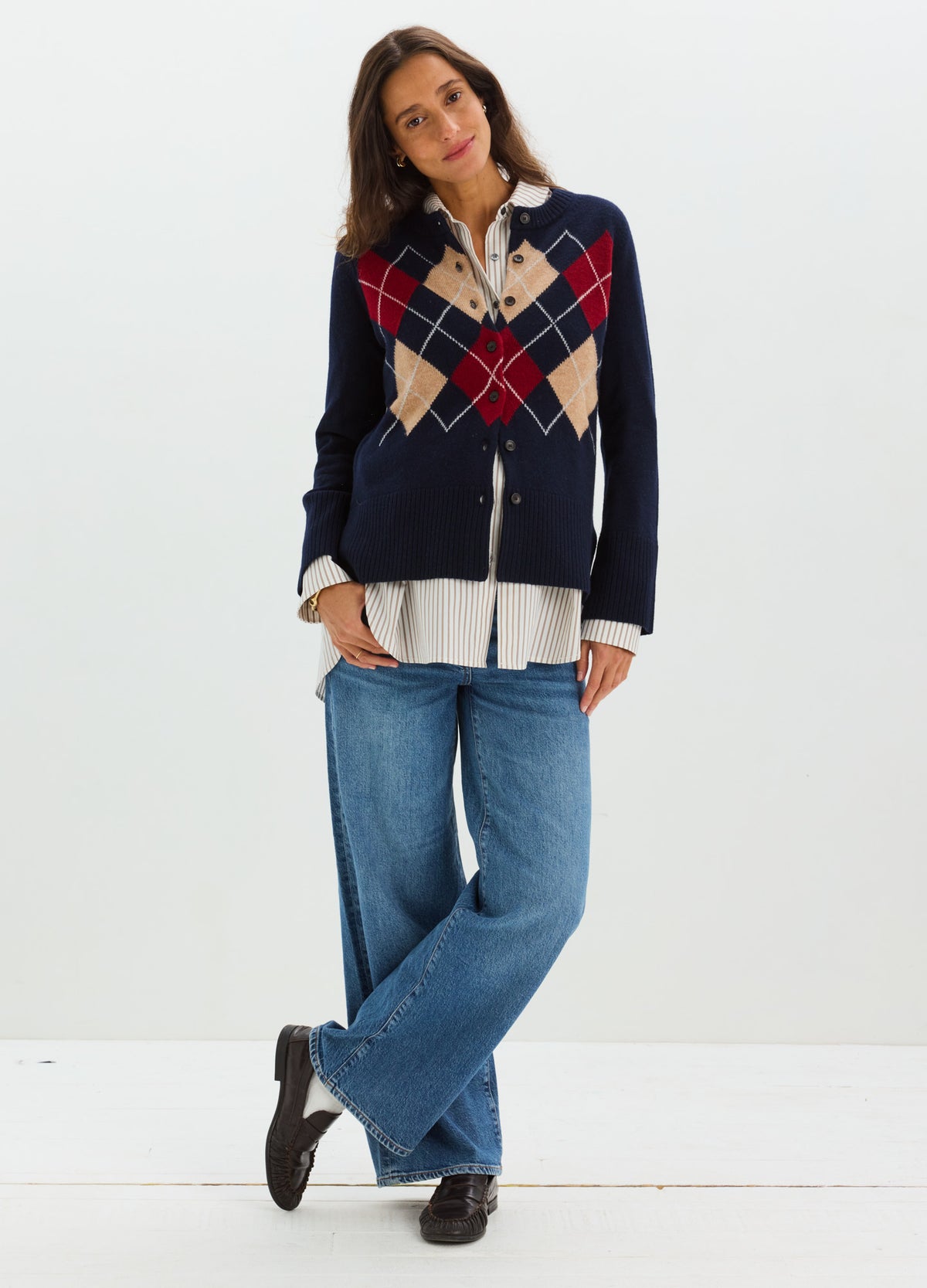 Navy blue maternity cardigan with red and beige argyle pattern, button-up front, worn open over white blouse and relaxed.