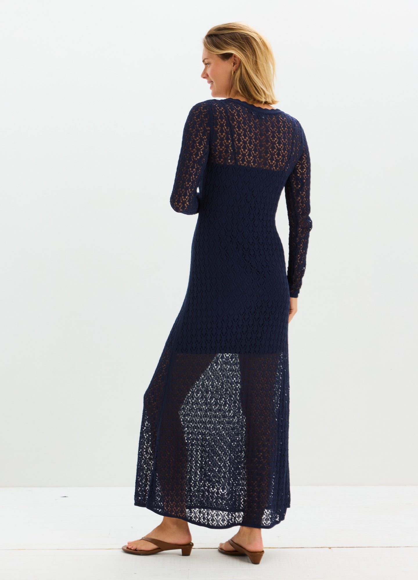 Navy blue sheer maternity maxi dress with long sleeves and textured knit design.