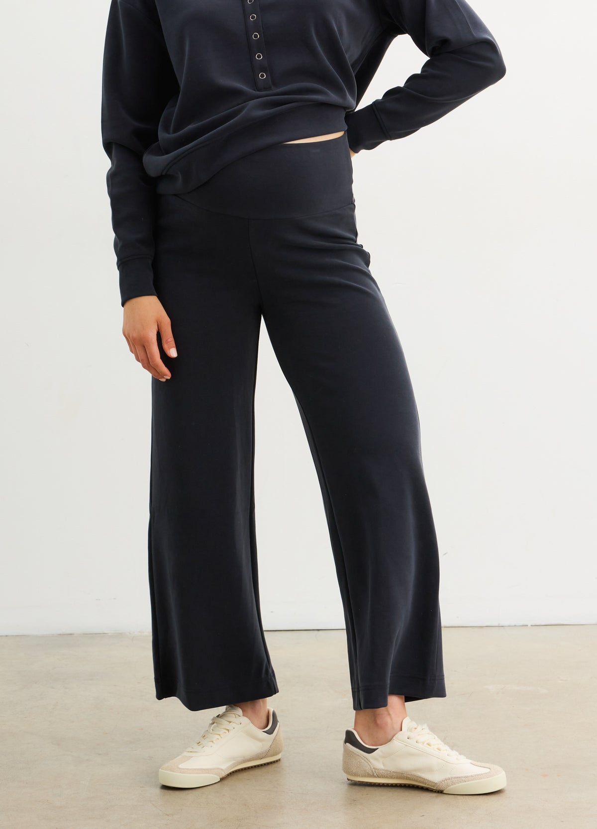 Black wide-leg maternity pants with a soft stretchy waistband designed for pregnant comfort.