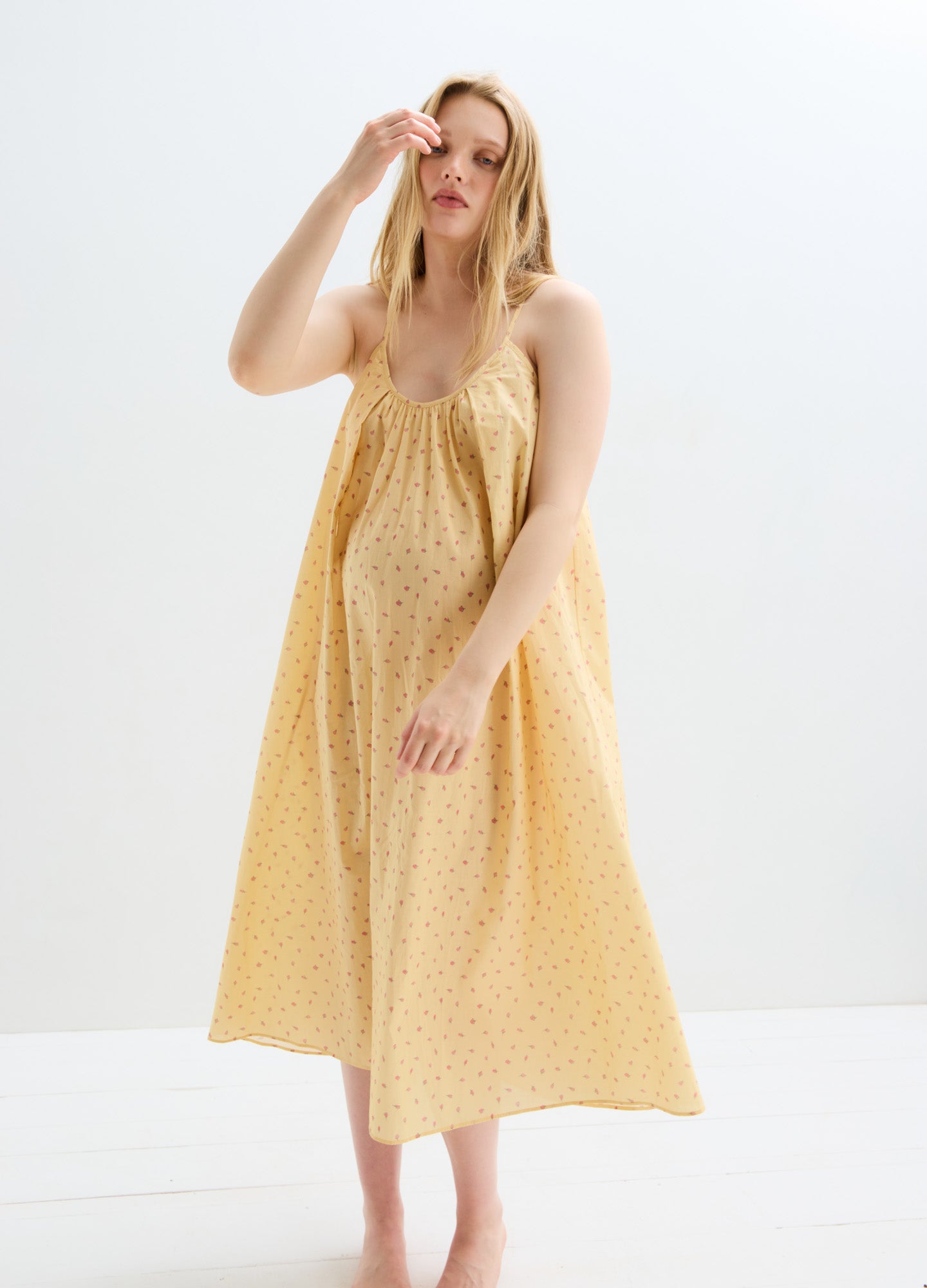 Light yellow cotton nursing nightgown with subtle polka dots, loose fit, and sleeveless design for maternity comfort.
