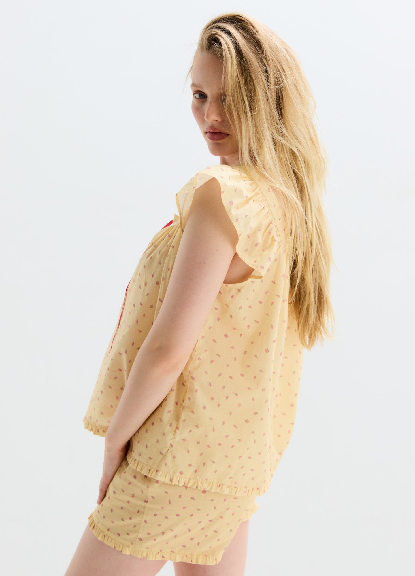 Light yellow cotton nursing pajama set with subtle floral print, sleeveless tank top and matching loose shorts.