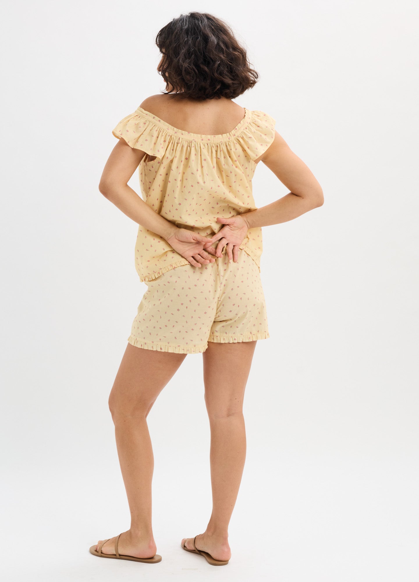 Light yellow cotton nursing tank top with ruffled off-shoulder sleeves and matching shorts with subtle polka dots.