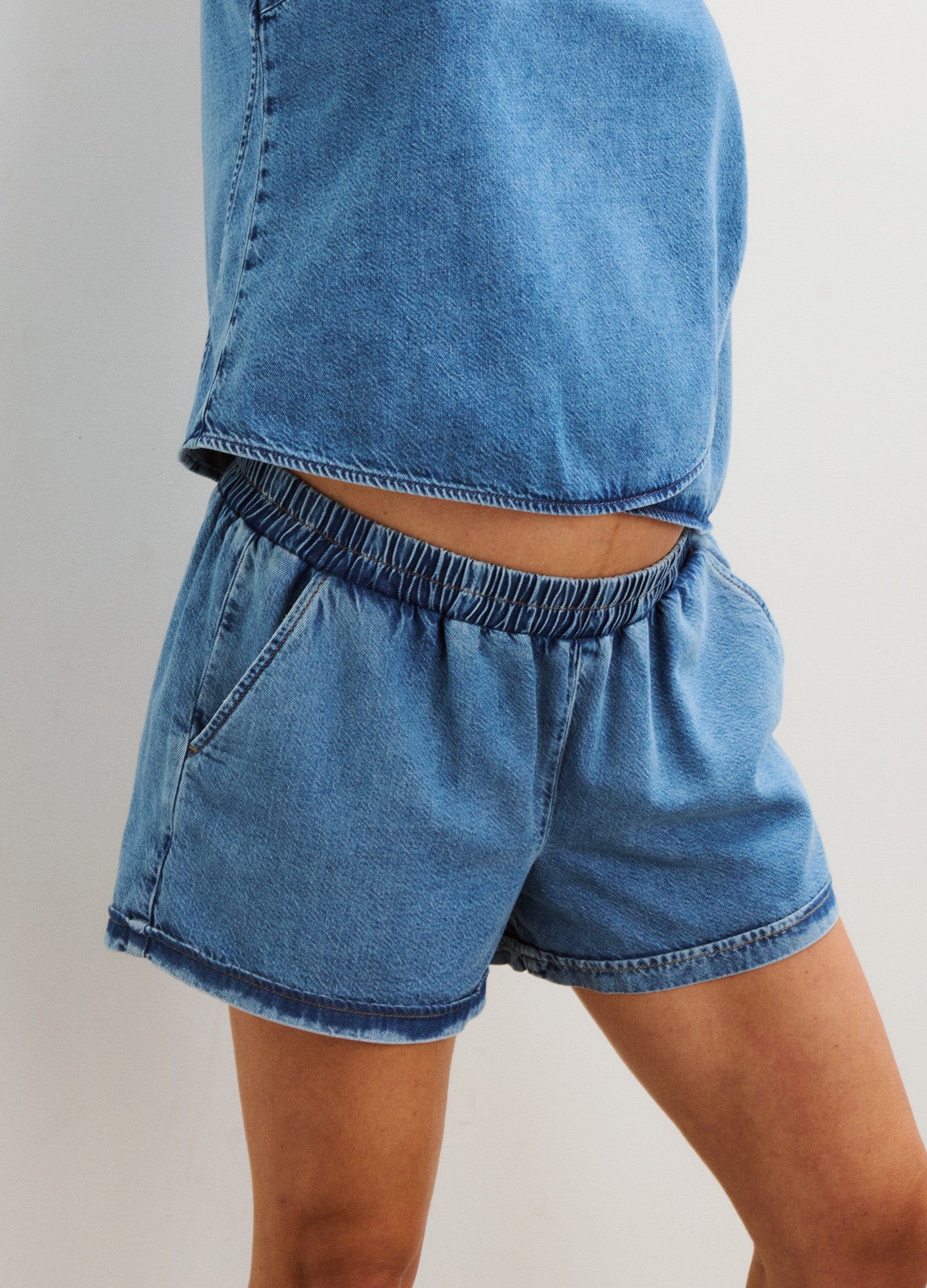 Blue denim maternity shorts with elastic waistband and relaxed fit for pregnant women.