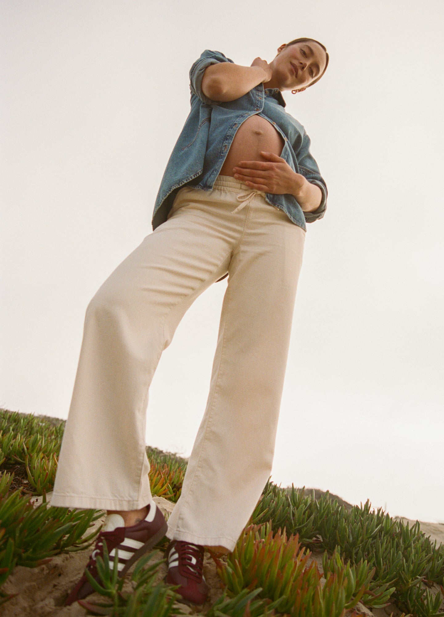 Light beige wide-leg maternity denim pants with high rise and soft drapey fabric.