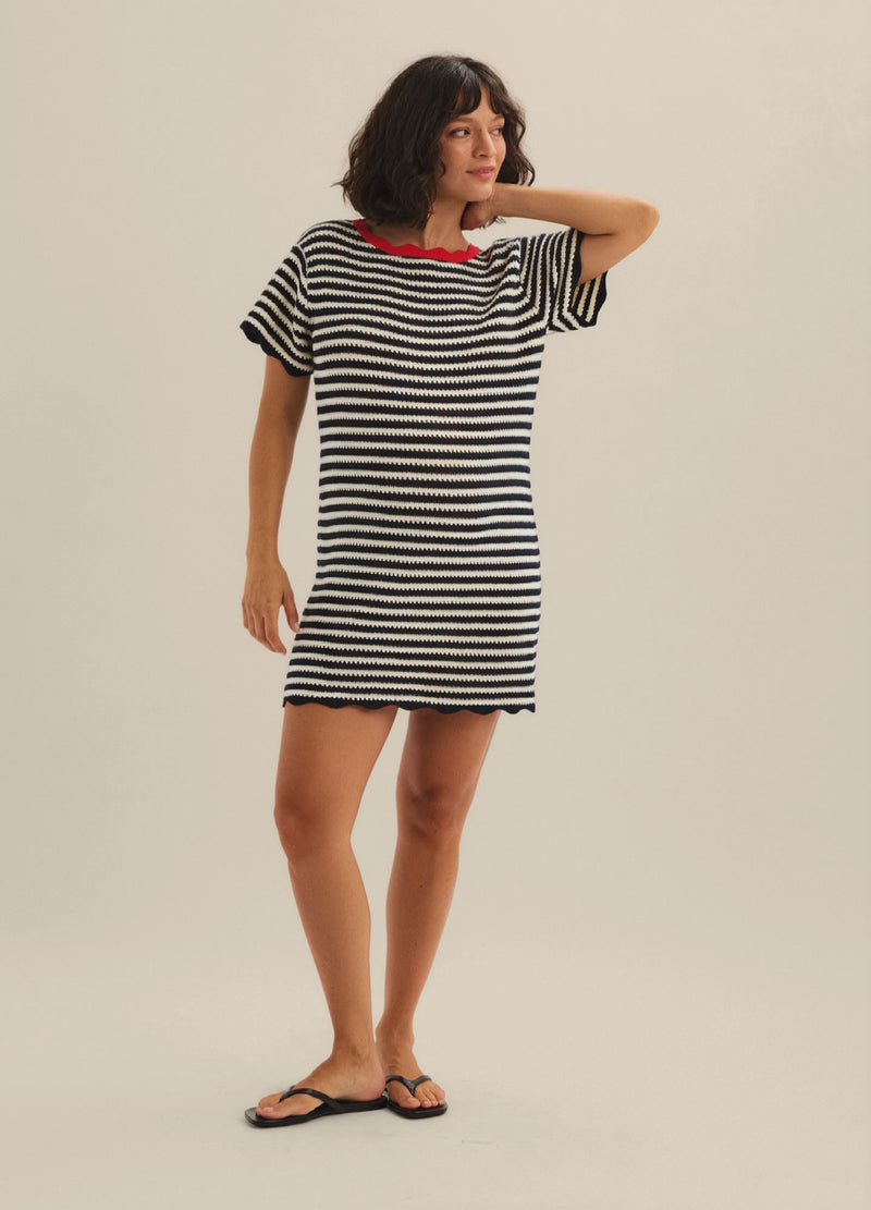 Black and white striped short-sleeve maternity mini dress with relaxed fit and red neckline trim.
