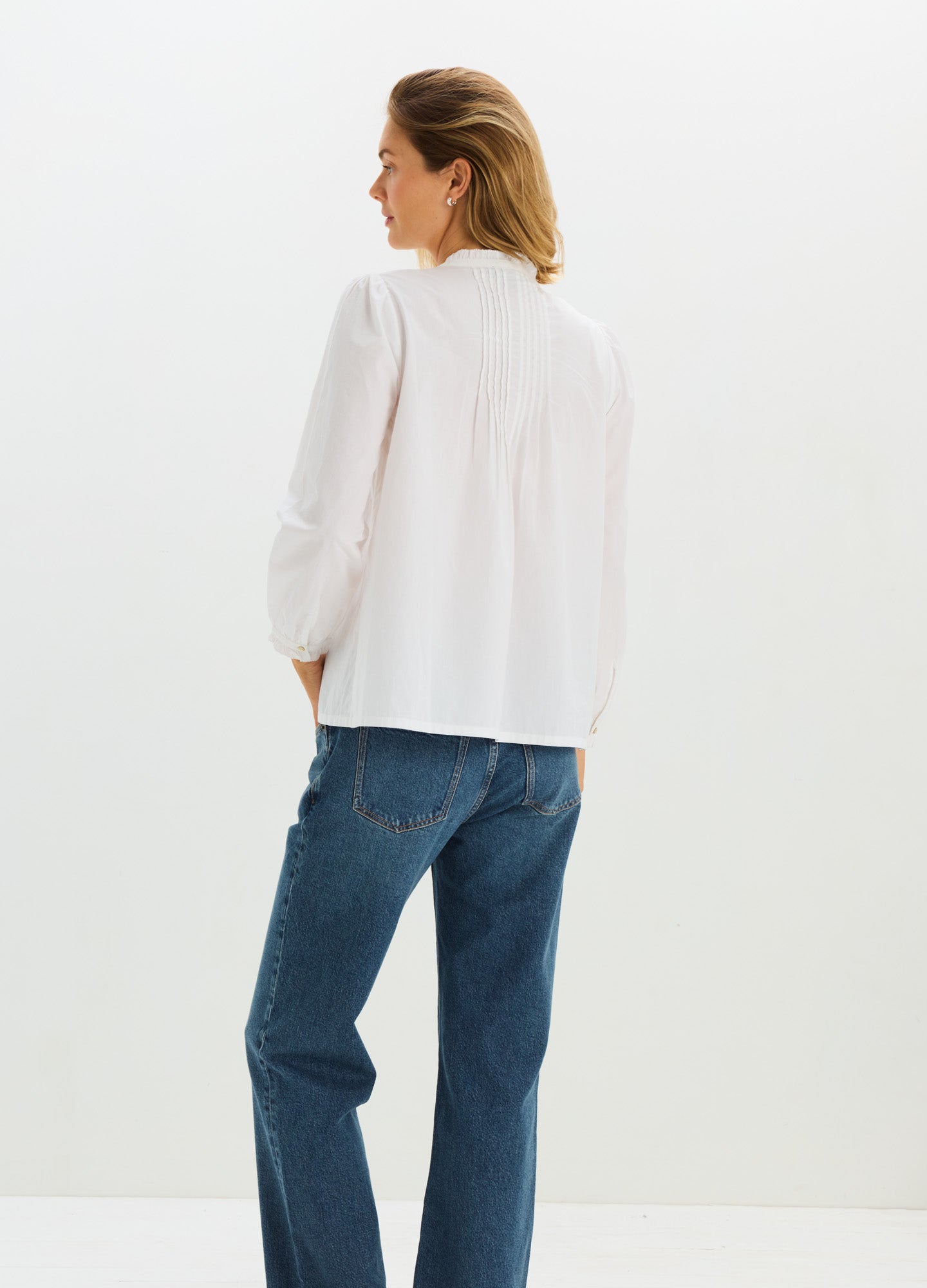 White long-sleeve maternity nursing blouse with a loose, flowy fit and subtle gathered detailing at the back yoke.