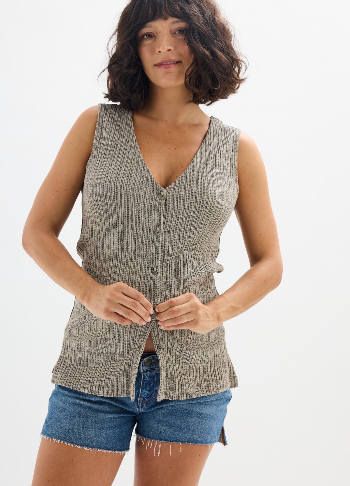Light brown ribbed knit maternity tank top with front buttons, worn with denim shorts.