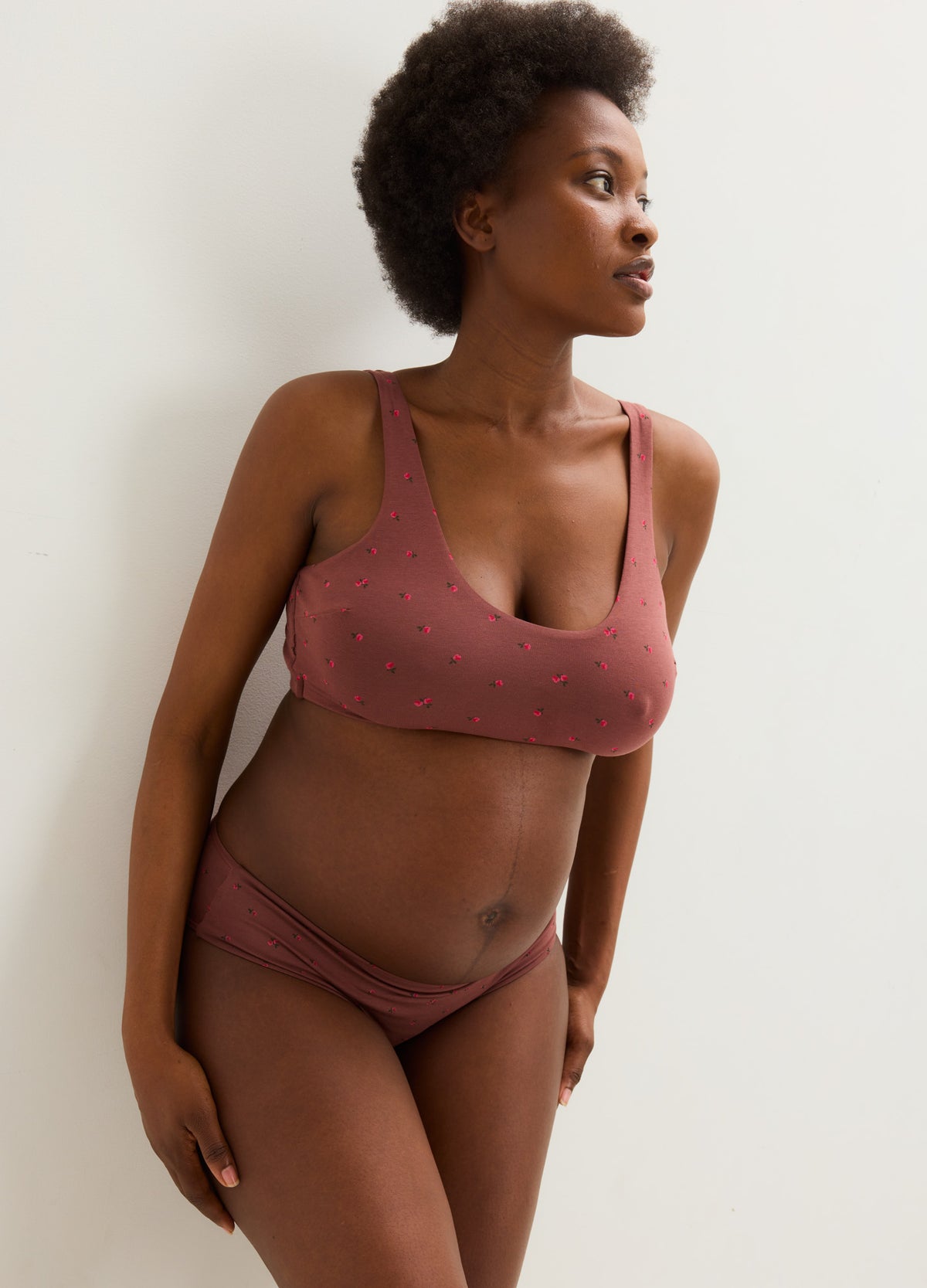 Maternity bralette and matching briefs in soft dusty rose with subtle floral print, designed for pregnant comfort.