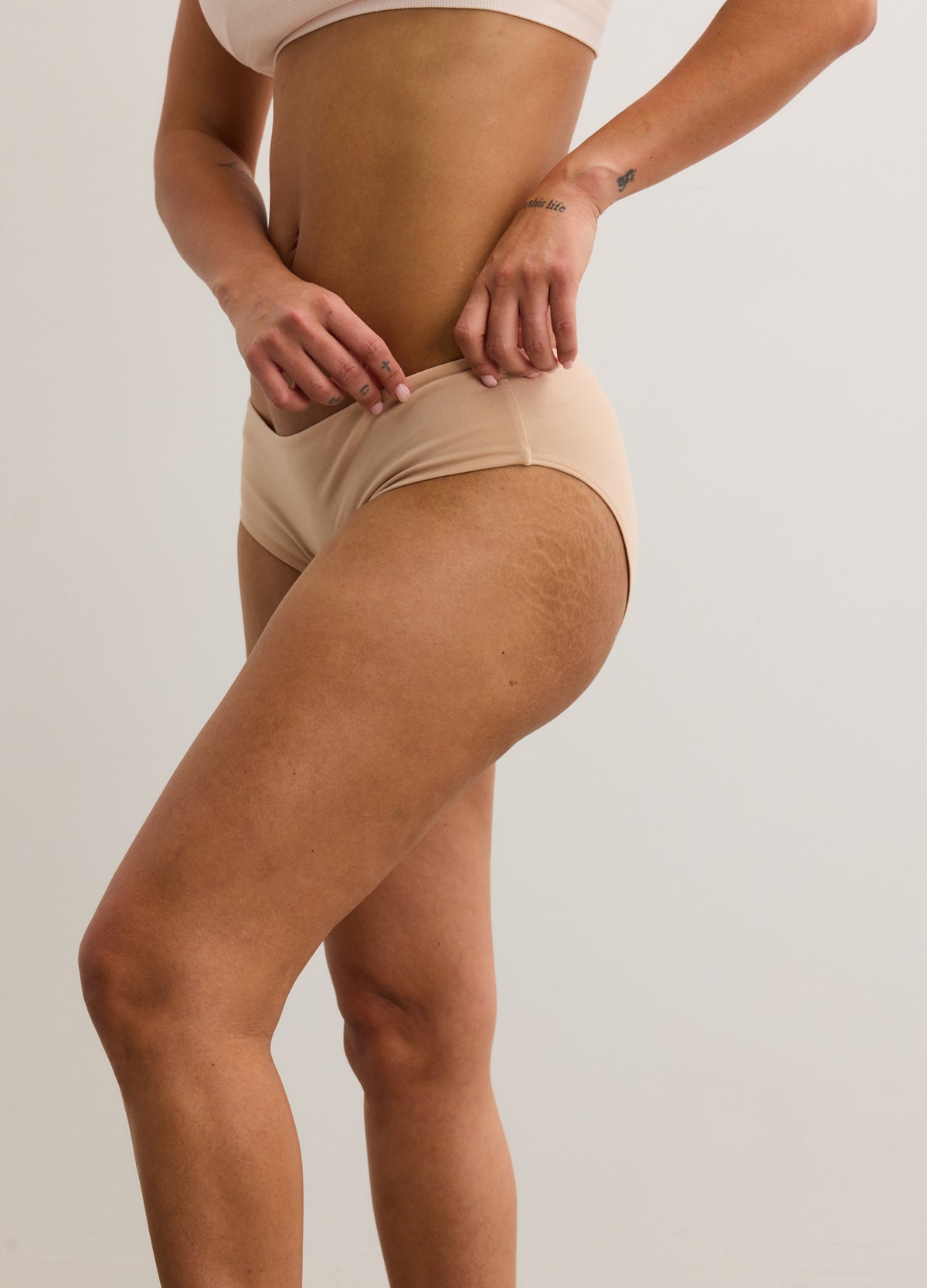 Beige seamless maternity brief with full coverage and soft, stretchy fabric.
