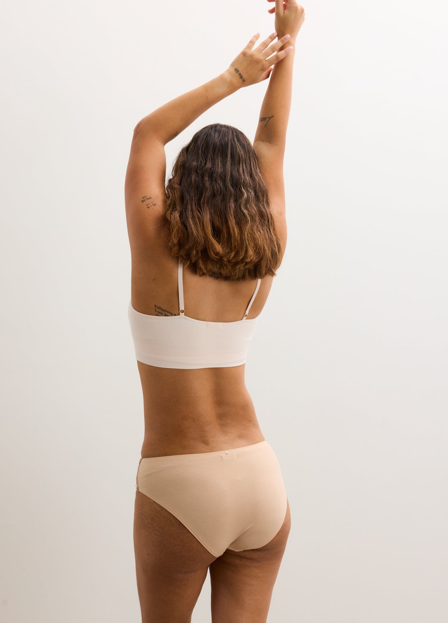 Seamless nude maternity brief with full coverage and soft stretch fabric.