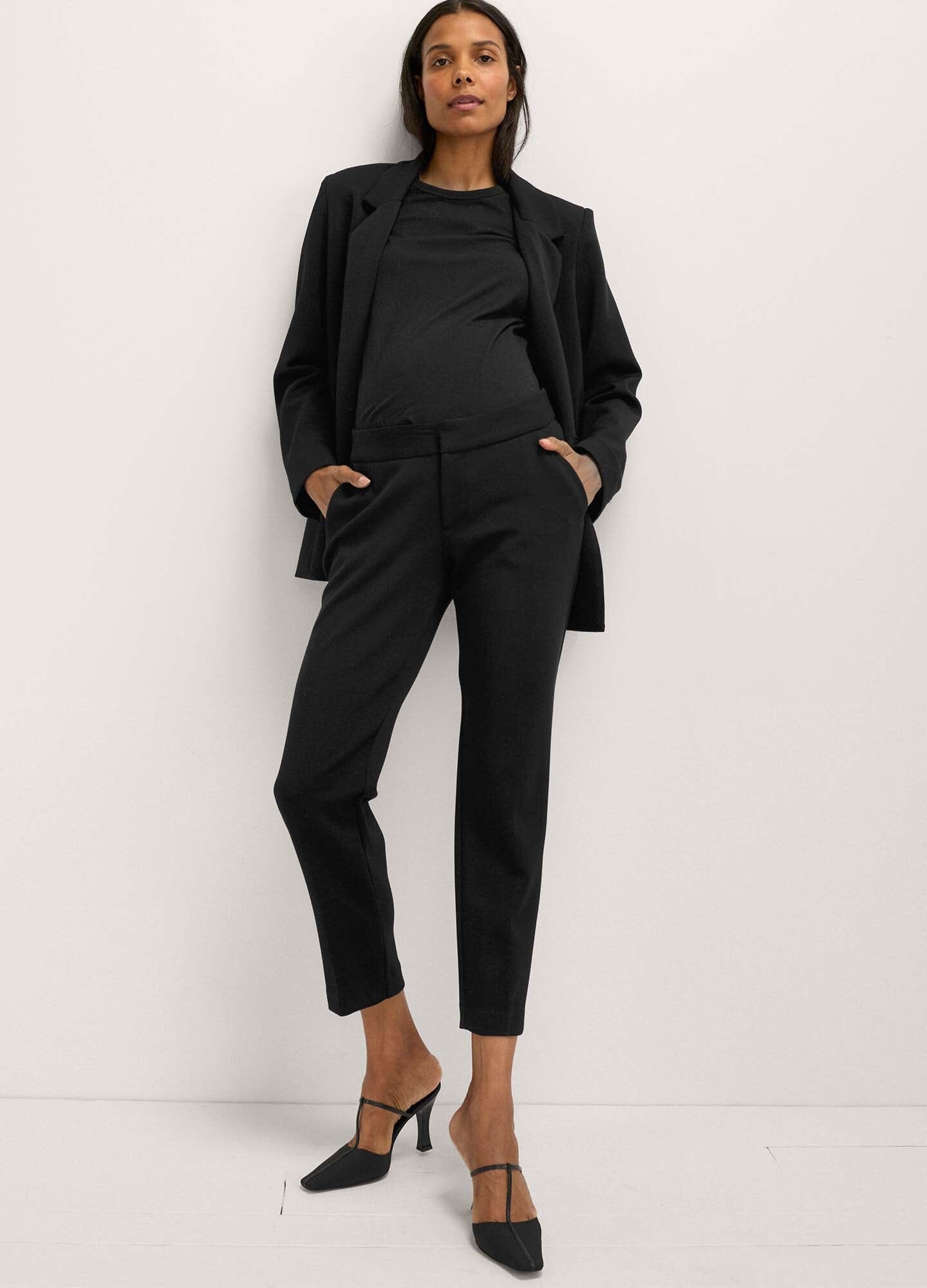 The HATCH Stretch Suit Pant - Black maternity stretch suit pants with tapered legs and front pockets, styled for pregnancy and postpartum wear.