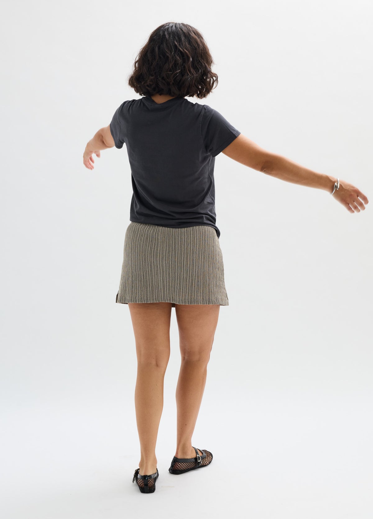 Olive green ribbed maternity skort with a comfortable fit, worn with a black t-shirt and flats.