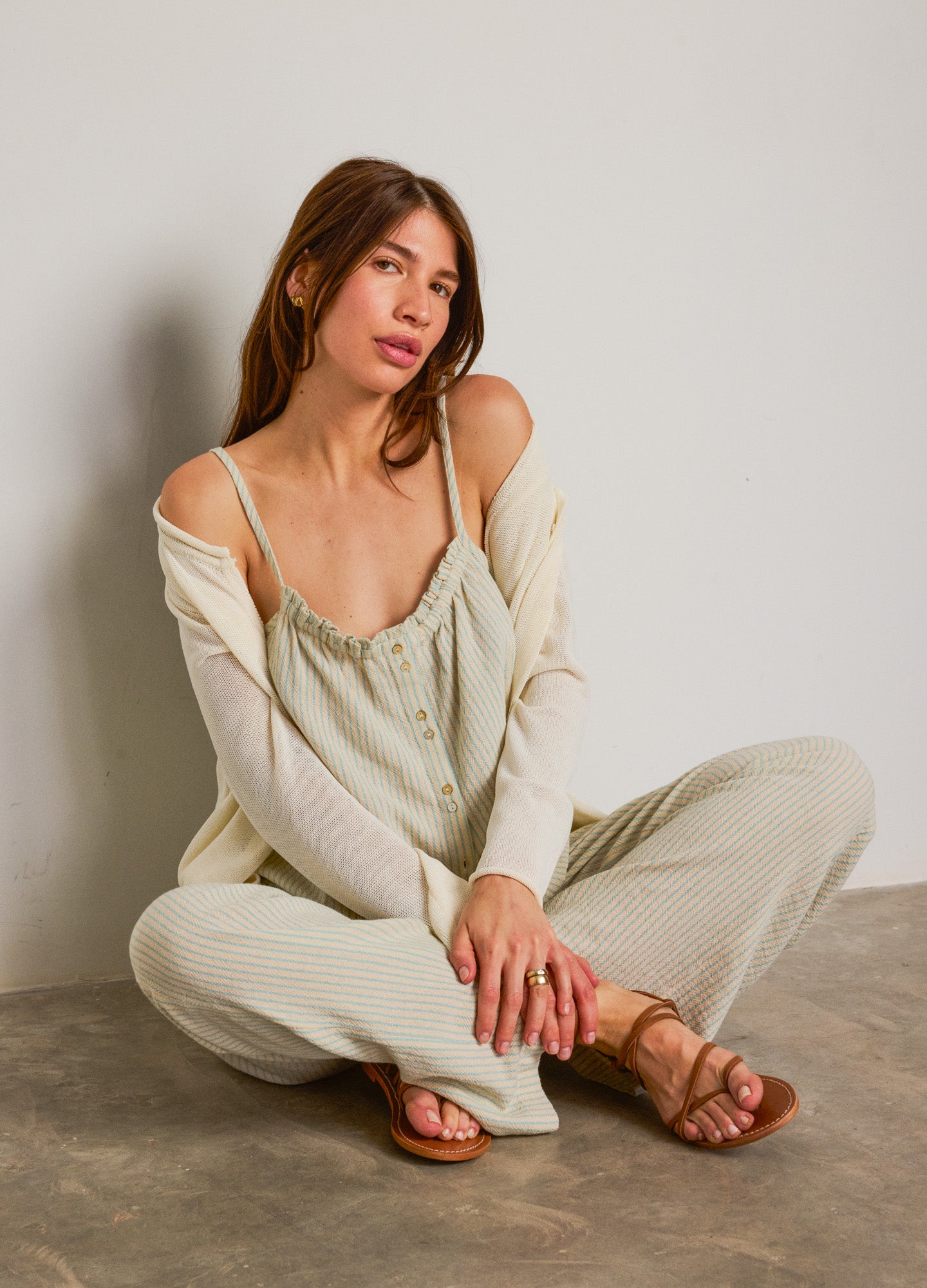 Light sage green nursing top with delicate ruffle trim, soft fabric, relaxed fit, paired with matching pants and sandals.