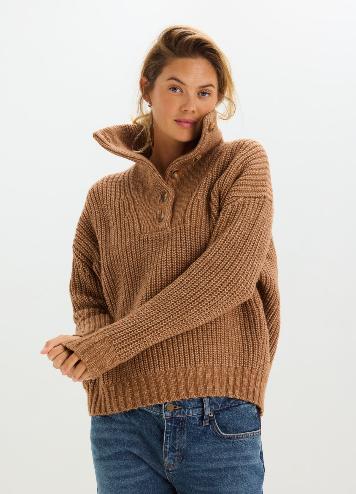 Brown ribbed knit maternity sweater with a relaxed, roomy fit, high collar, and button placket.