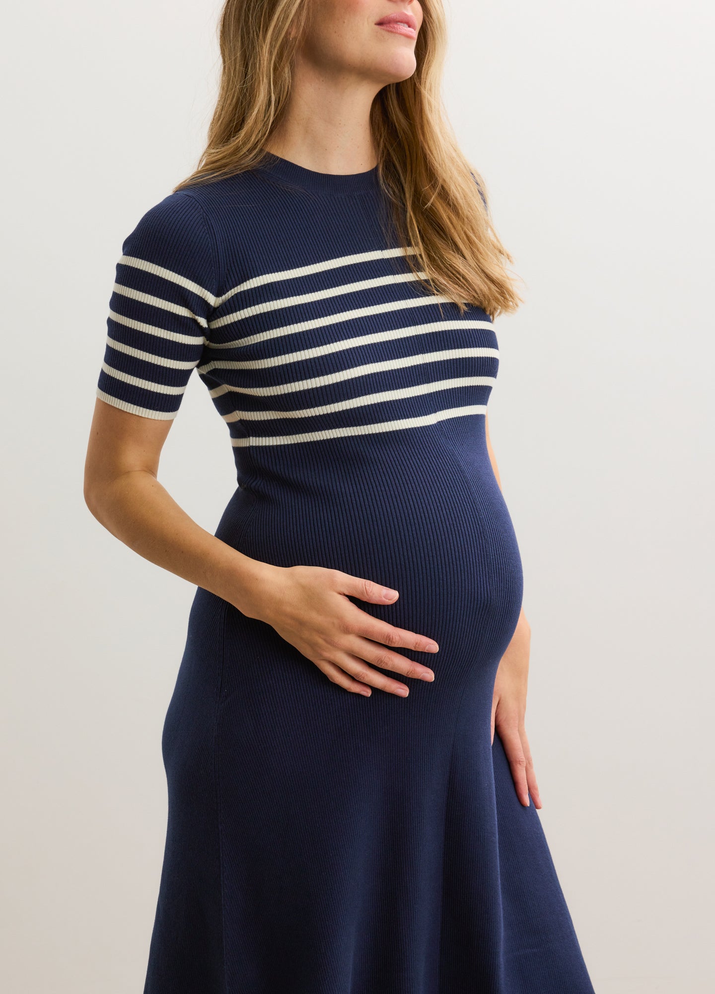 Navy blue and white striped cotton rib maternity dress with short sleeves and fitted silhouette.