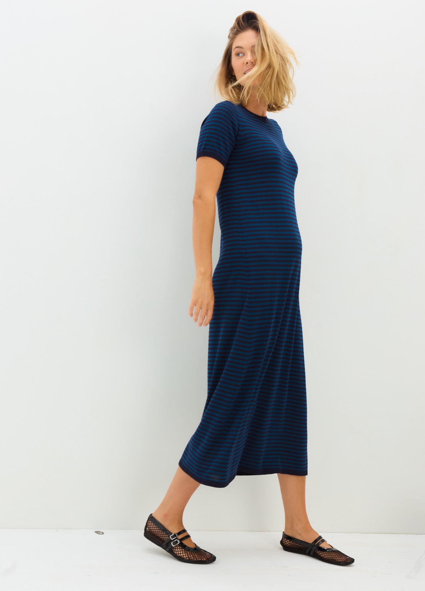 Navy blue short-sleeve knit midi dress with a fitted silhouette, designed for maternity wear.