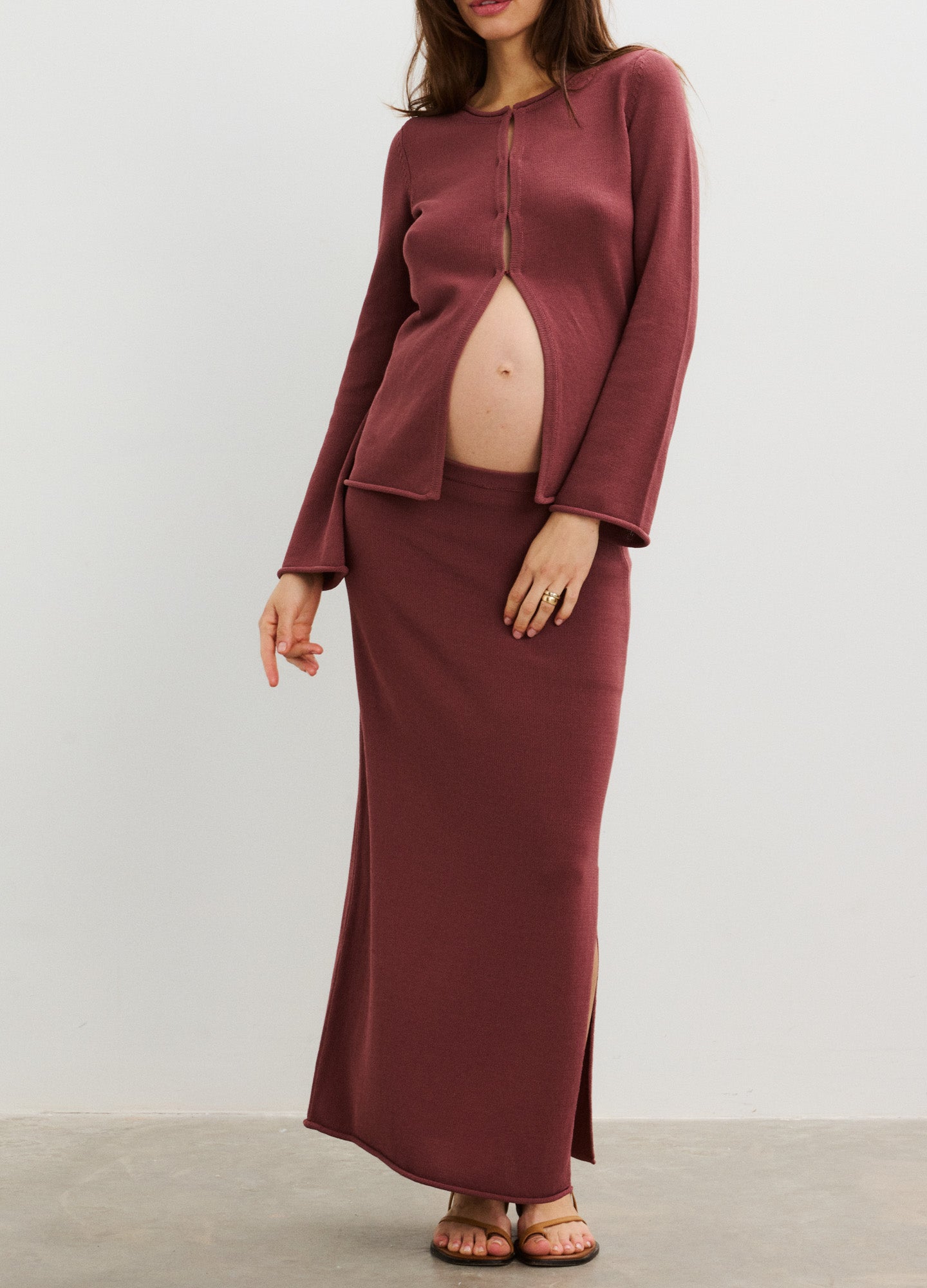 Mauve long-sleeve maternity top with front button closure paired with matching maxi skirt.