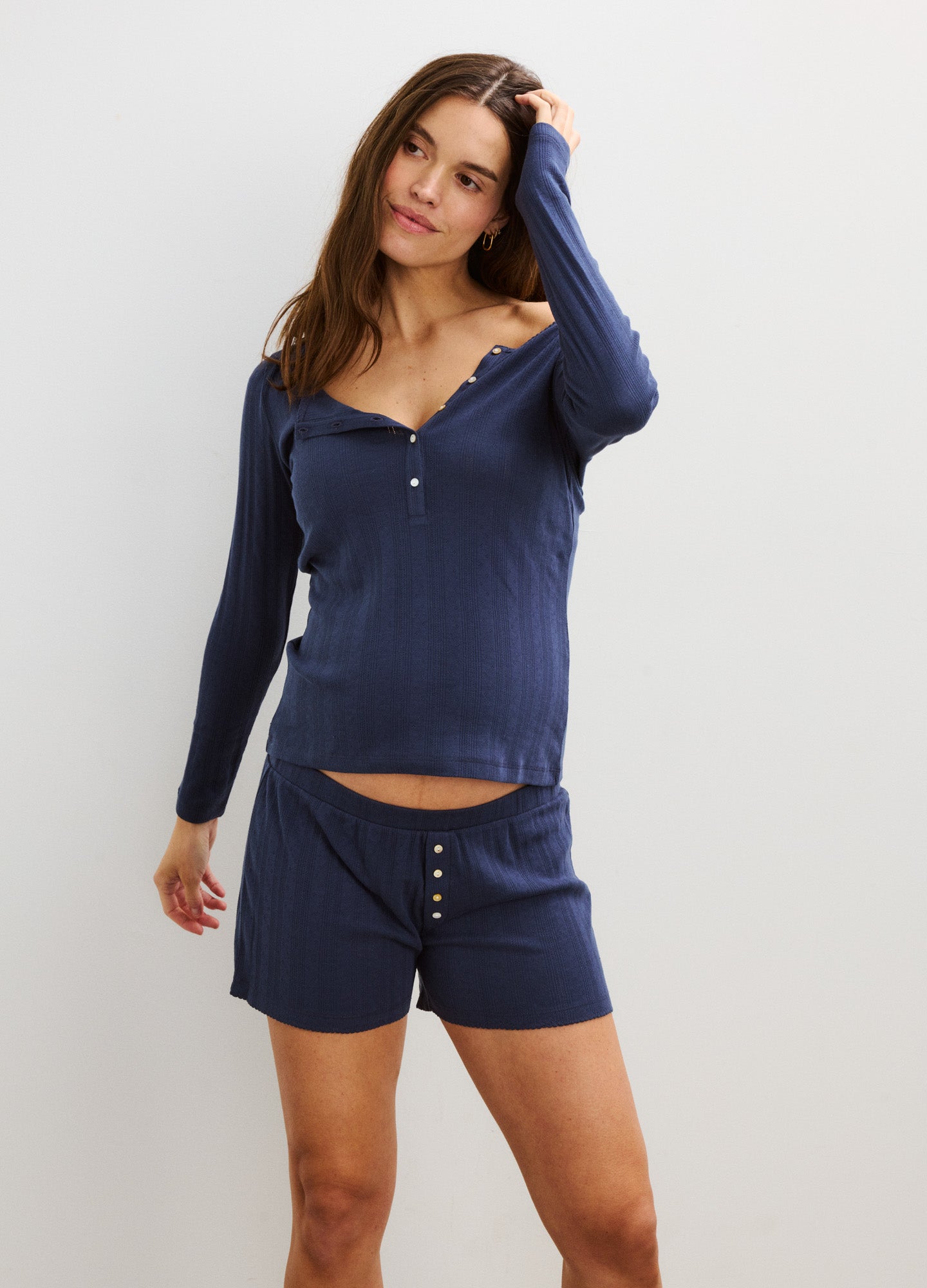 Navy blue long sleeve pointelle knit henley top paired with matching buttoned shorts designed for maternity comfort.