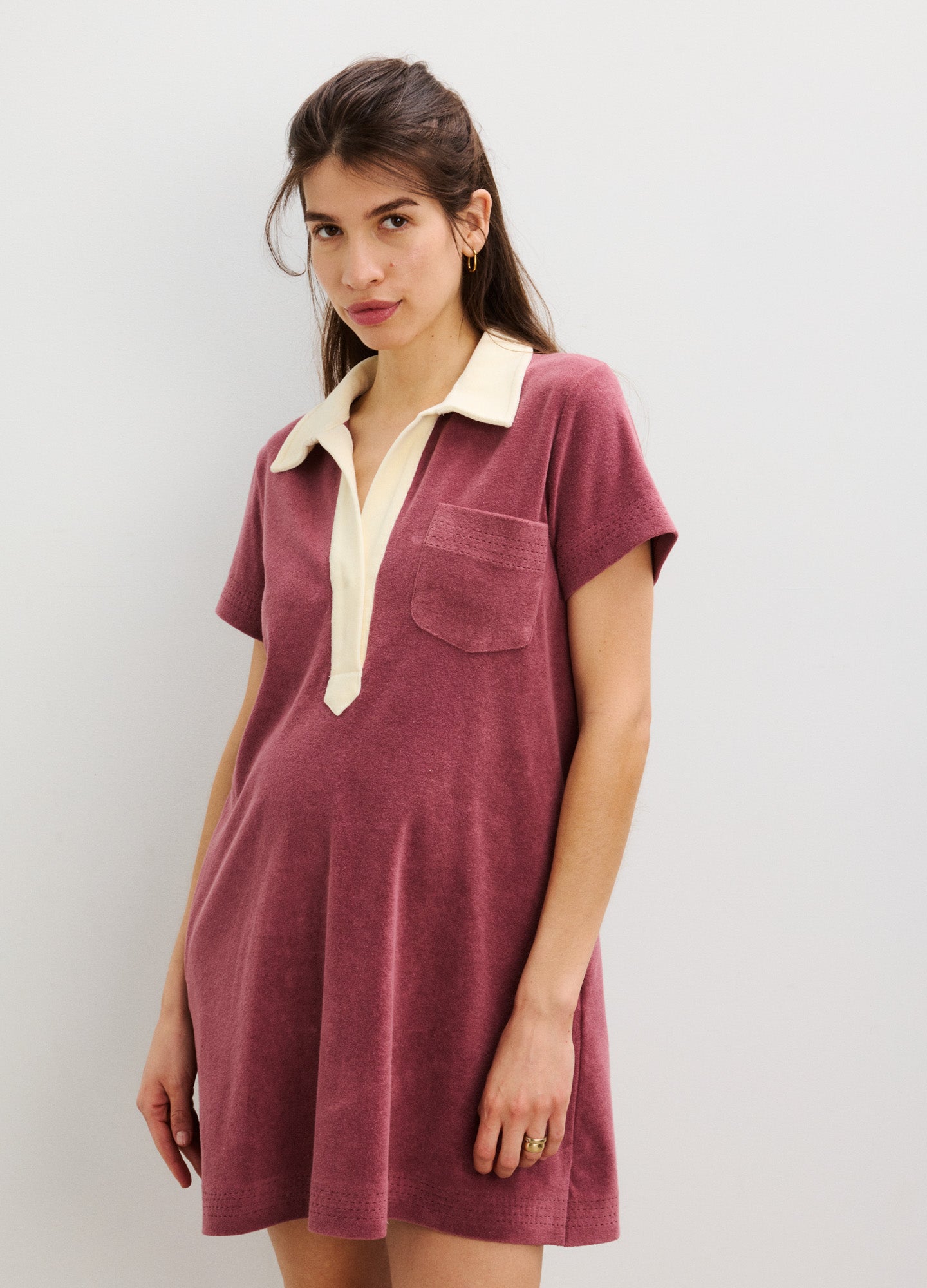 Maternity dress in soft dusty rose with short sleeves, cream collar, front pocket, and relaxed fit.