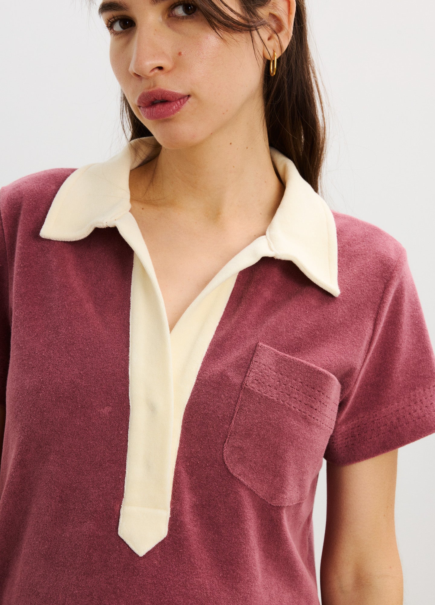 Mauve maternity dress with short sleeves, cream collar, V-neck placket, and front chest pocket.