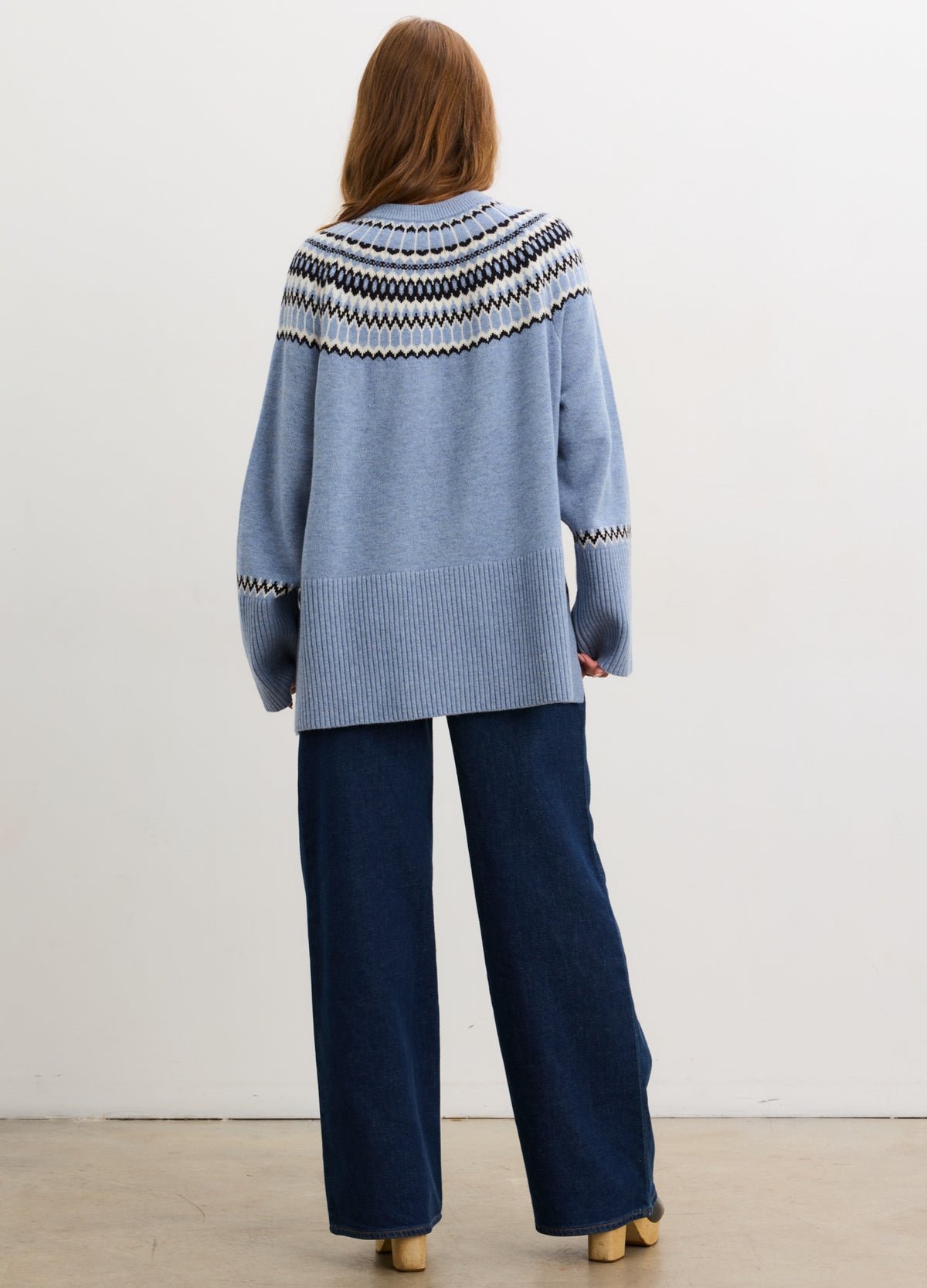 Light blue Fair Isle pullover with white and navy pattern on yoke, relaxed fit, knit fabric.