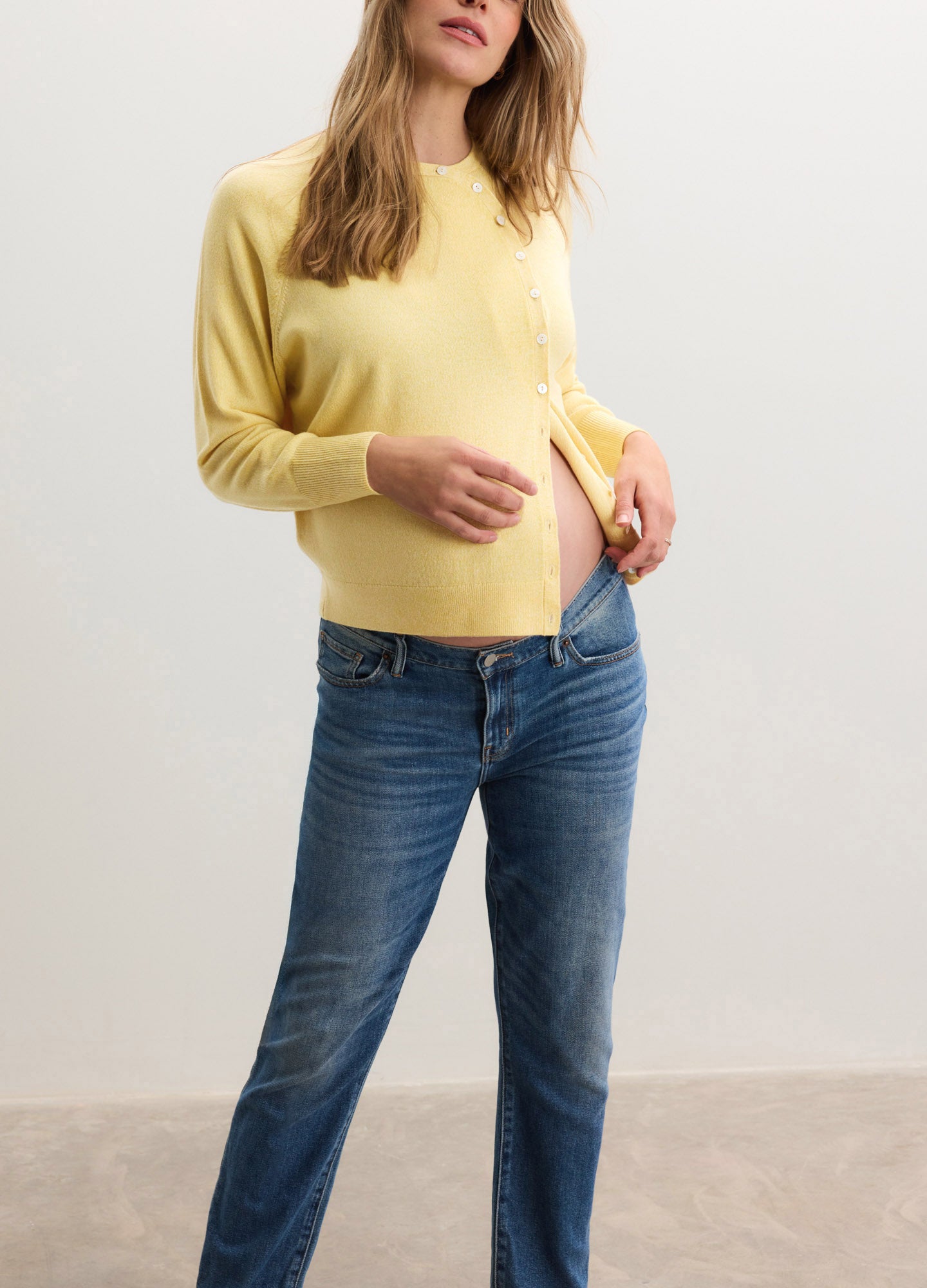Soft yellow maternity cardigan with long sleeves and a comfortable, relaxed fit designed for pregnant women.
