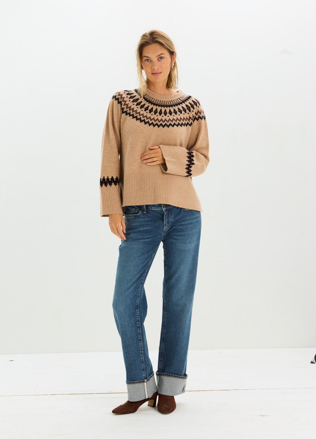 Beige Fairisle knit sweater with black geometric trim, styled for a relaxed maternity fit.