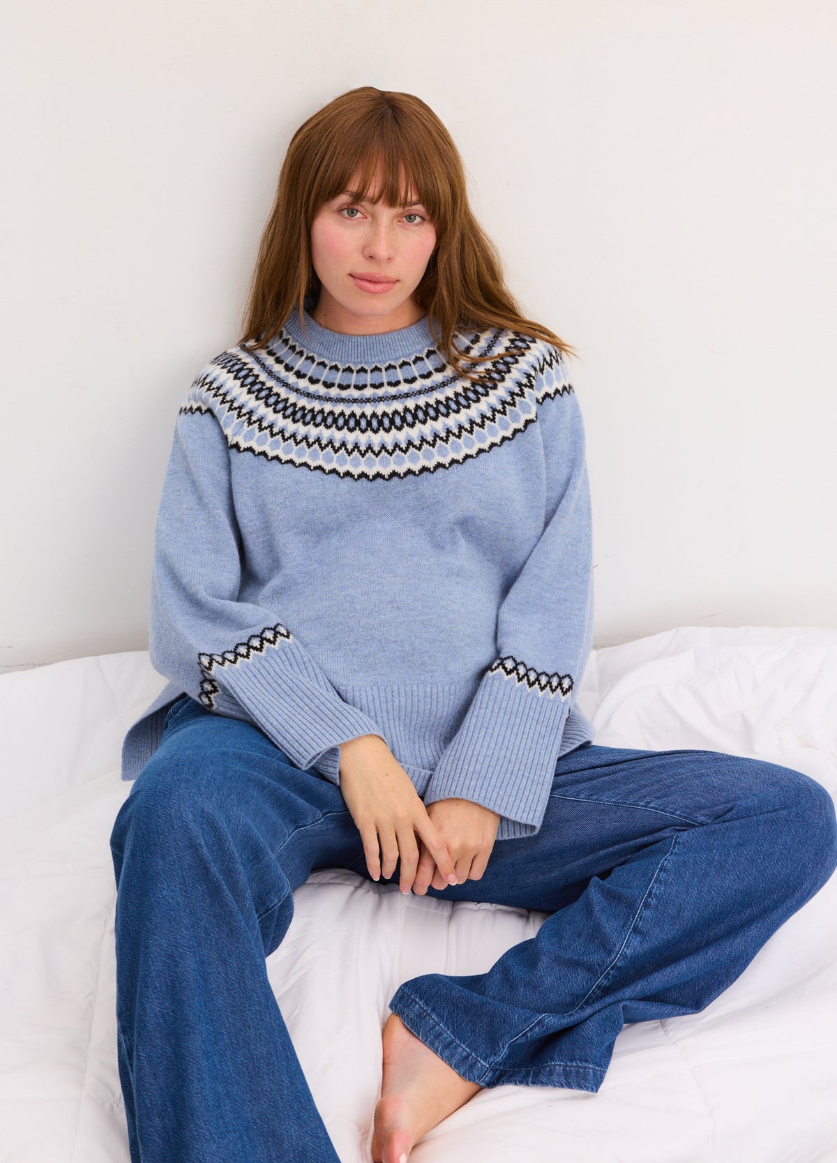 Light blue cashmere pullover with brown and white Fair Isle yoke and wide bell sleeves.