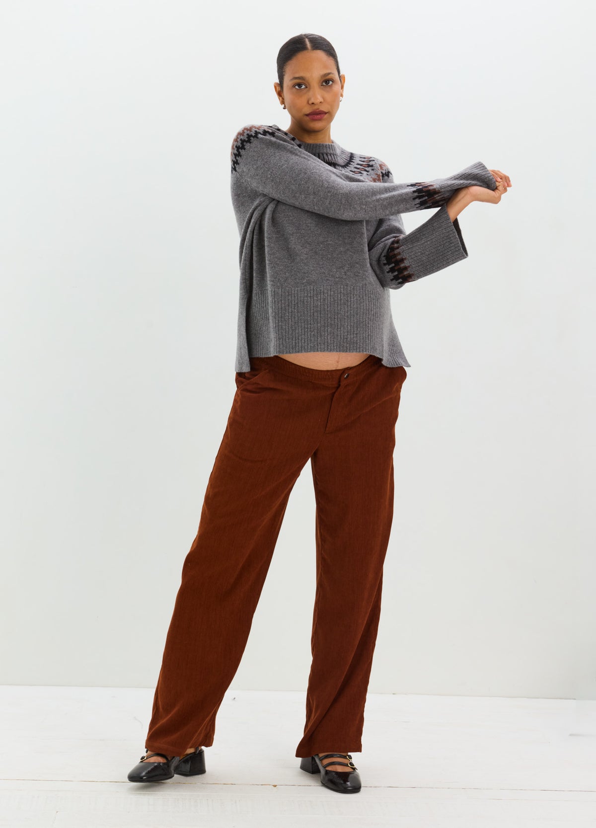 Gray Fair Isle sweater with a relaxed fit, patterned shoulders, and ribbed cuffs and hem.