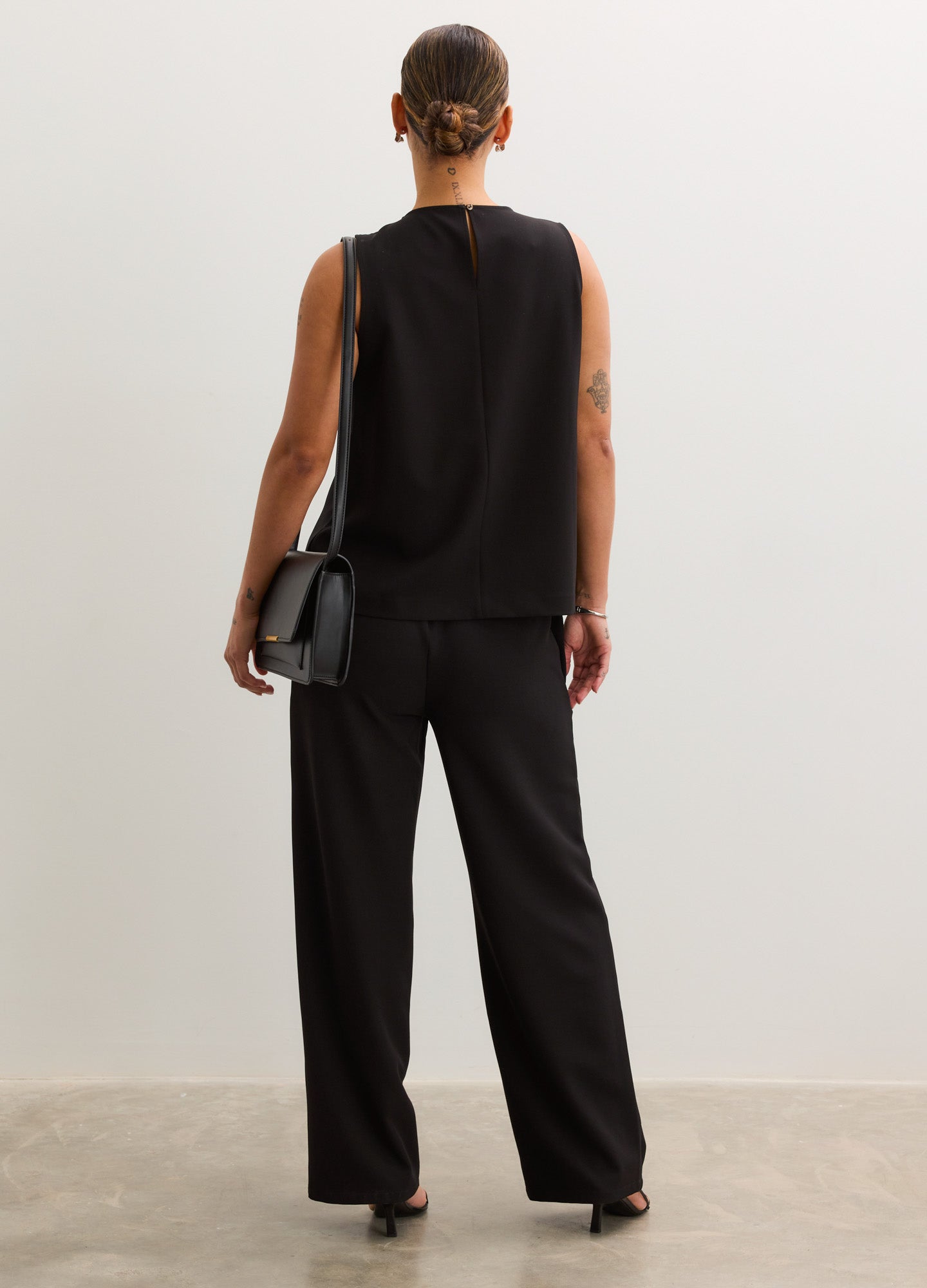 Black maternity pants with a straight-leg cut, elastic waistband, and soft, stretchy fabric.