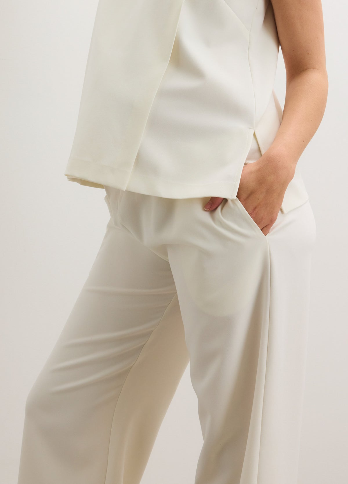 Cream-colored maternity pants with a relaxed fit and soft, stretchy fabric designed for comfort.