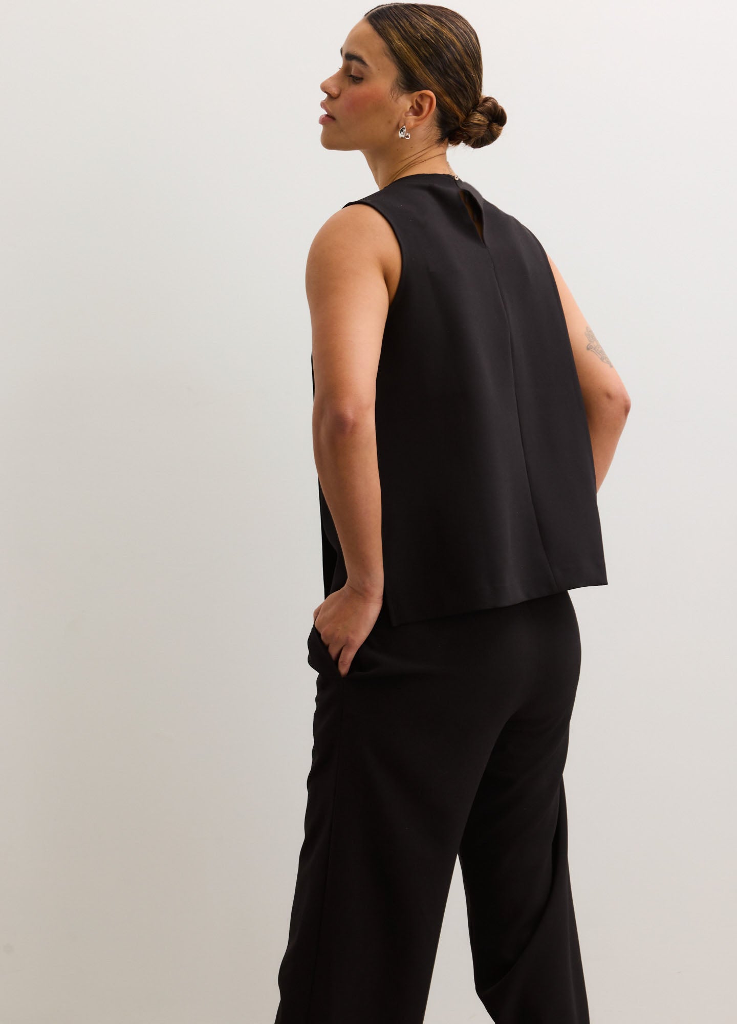 Black sleeveless maternity nursing tank with a relaxed fit and smooth fabric.