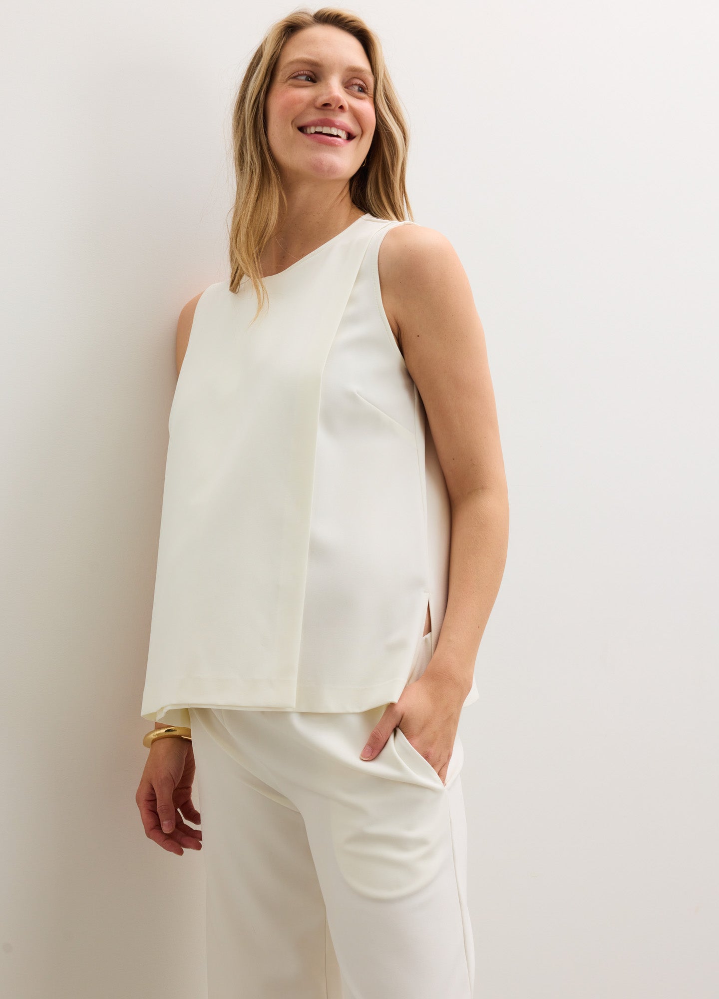 Cream-colored sleeveless nursing tank with a relaxed fit and soft, breathable fabric designed for maternity comfort.